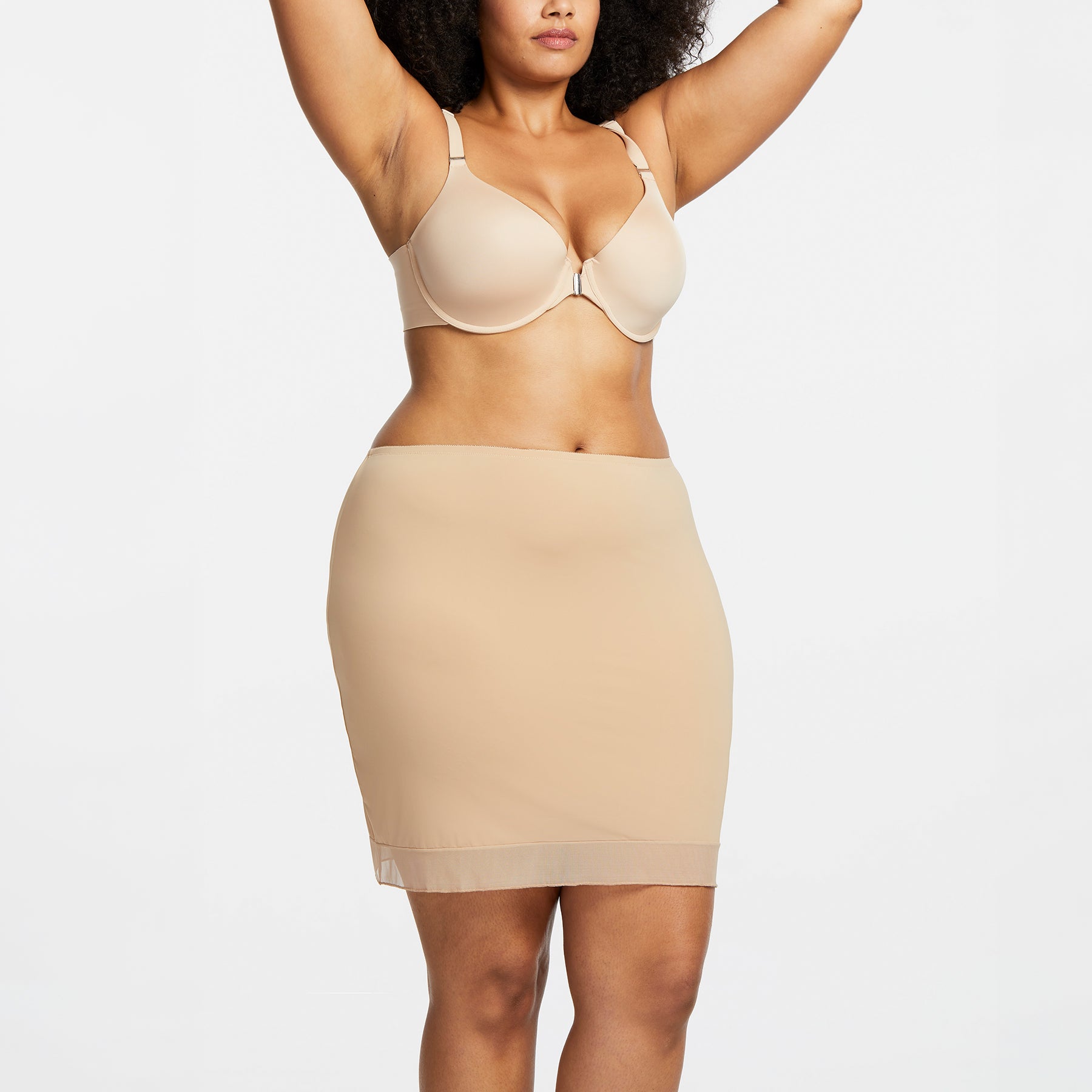 Montelle Intimates 9502 18-inch half slip above knee in Sand colour with smooth invisible silhouette and sheer trim, front view on curvy model.