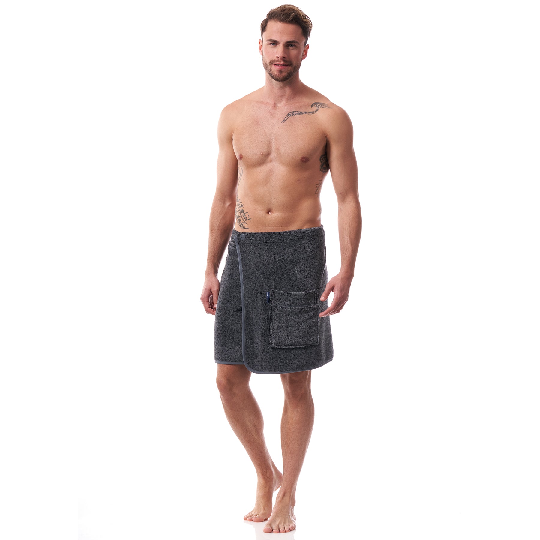 Man wearing charcoal grey men’s towel wrap – lightweight, soft, and secure for spa, beach, or home use. Front view.
