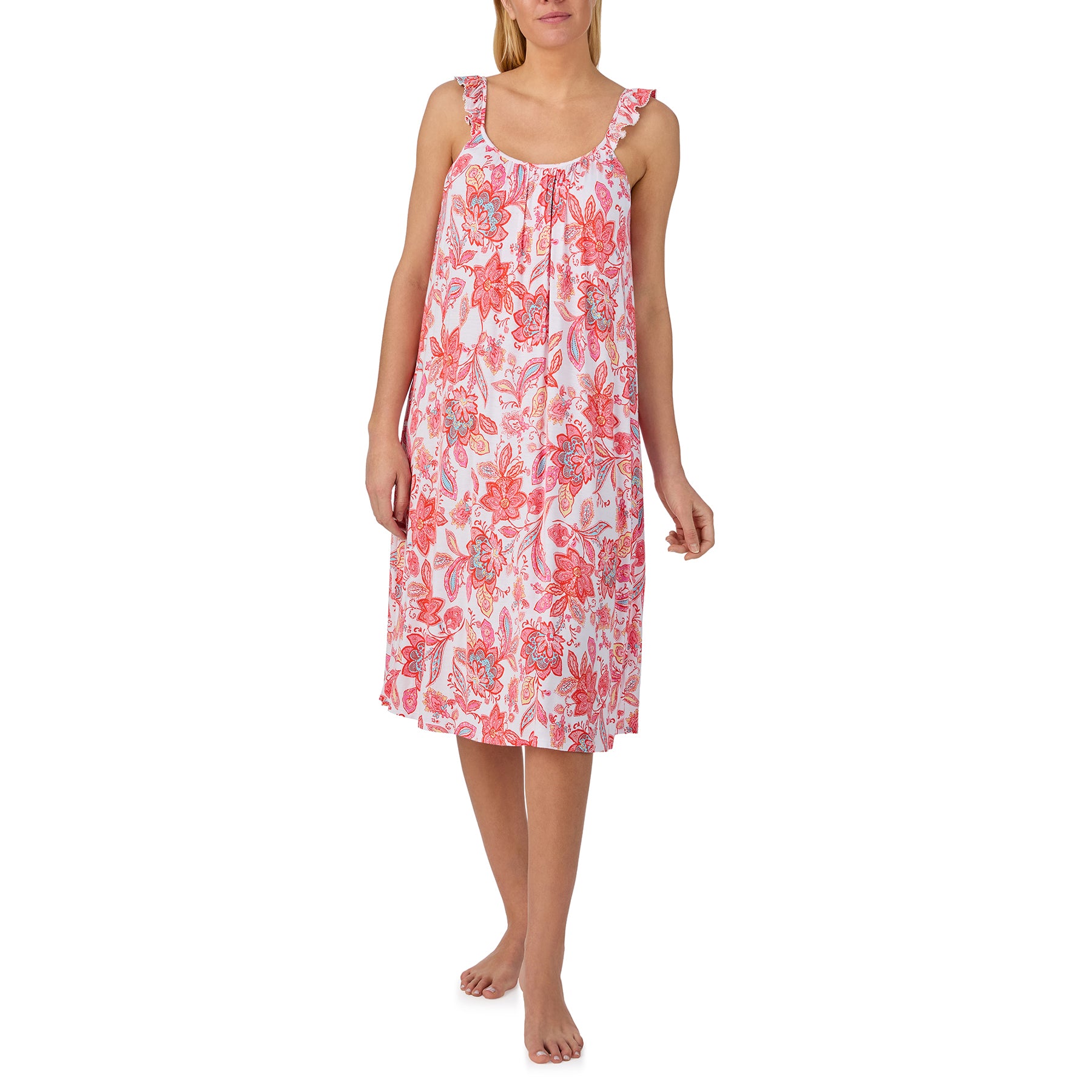 Woman wearing a sleeveless pink nightgown with coral paisley floral print and ruffle shoulder straps