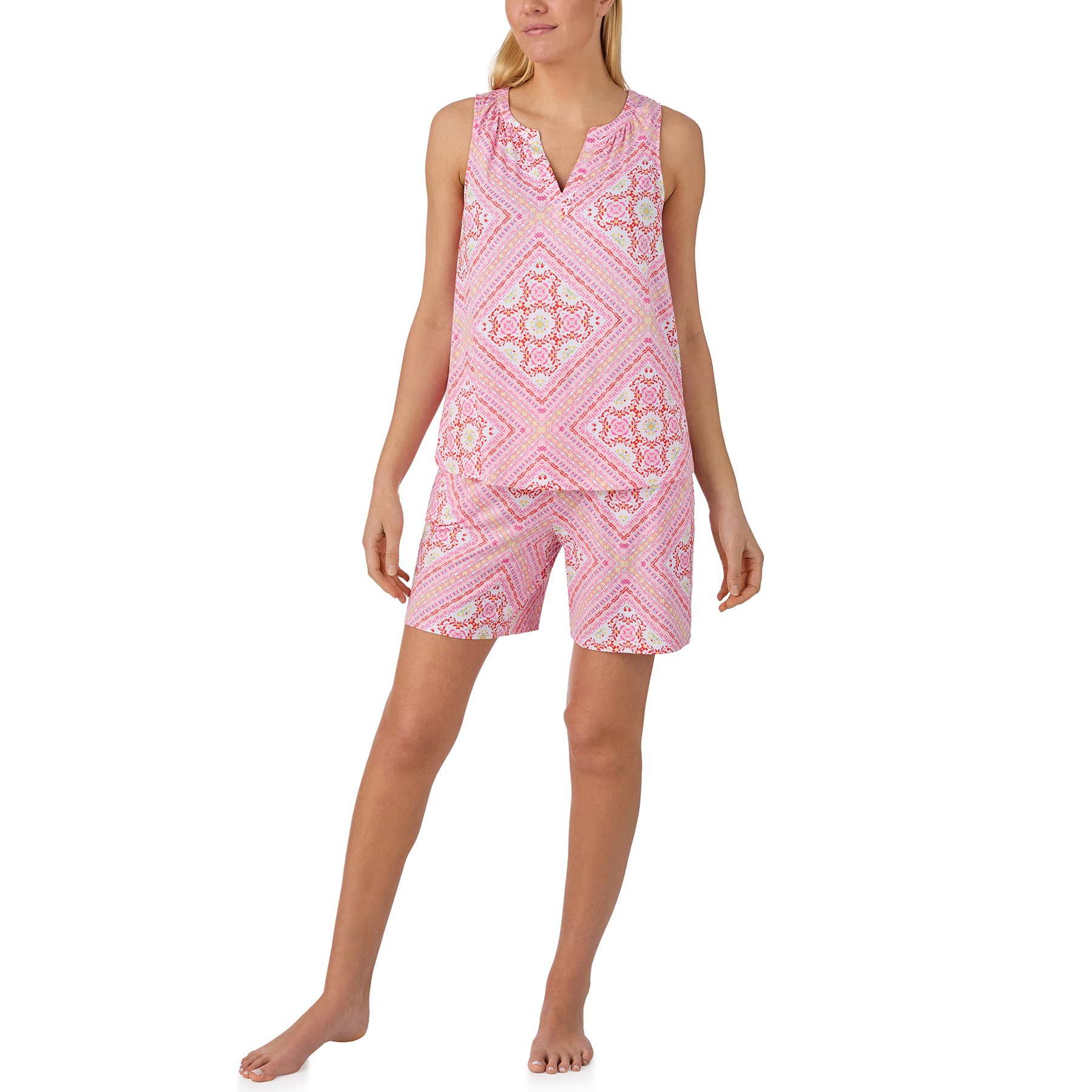 Woman wearing a pink sleeveless pajama set with matching printed shorts and decorative scarf-inspired pattern