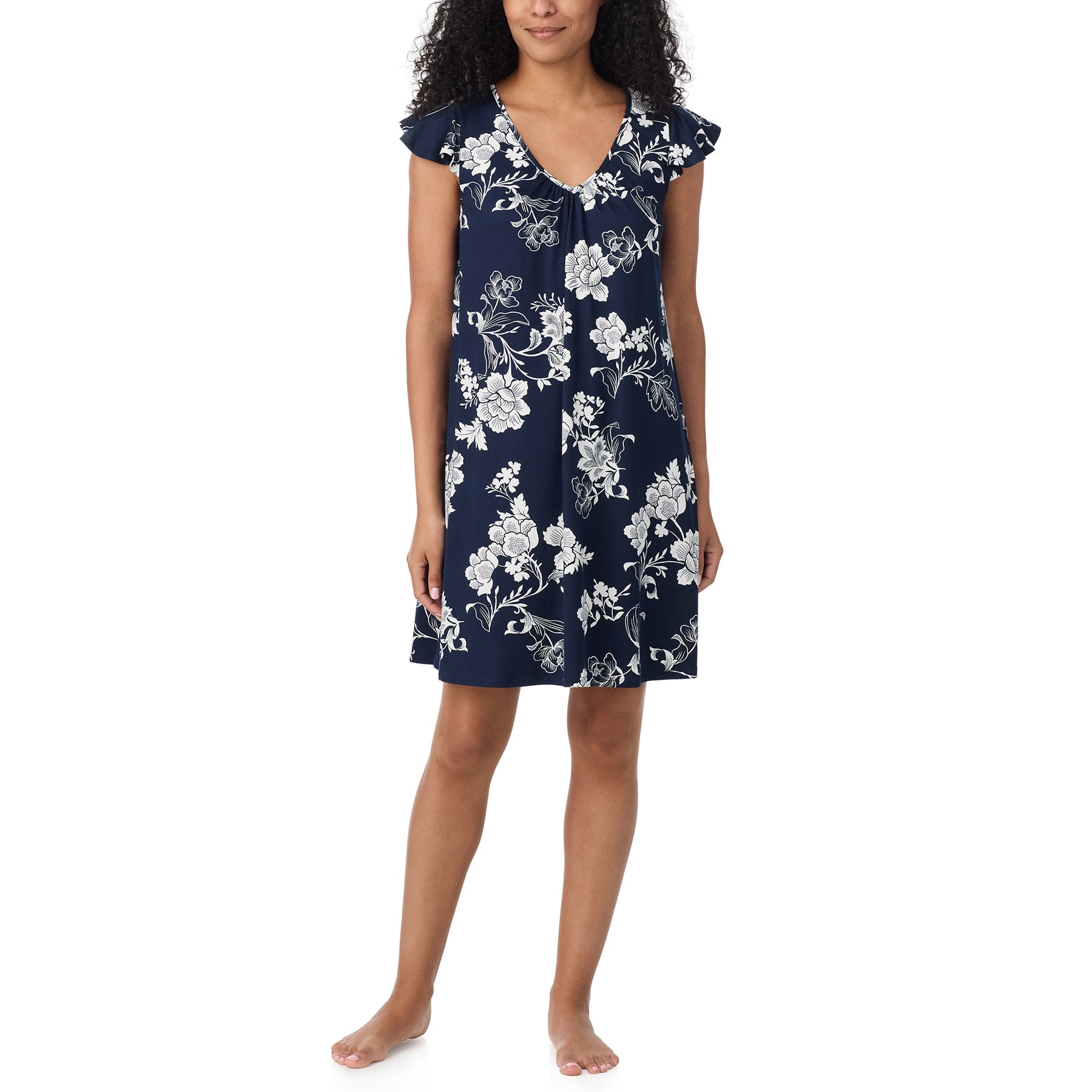Front view of woman wearing a navy and white floral short nightgown with a V-neckline, flutter sleeves and relaxed A-line fit.