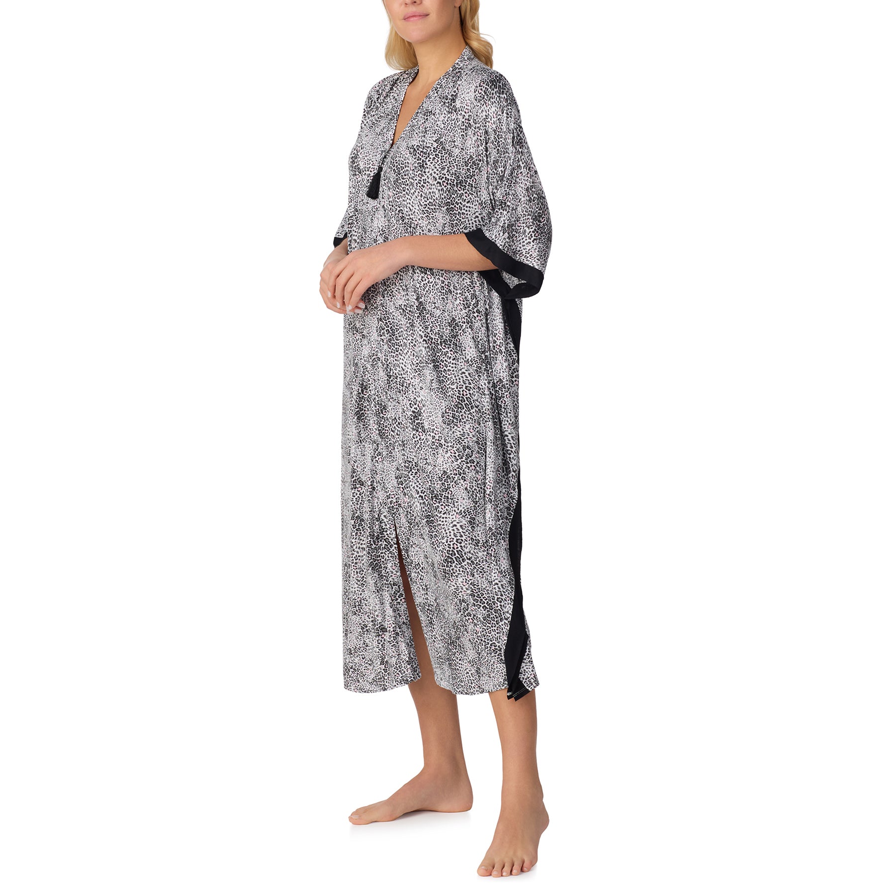 Side view of leopard print kaftan with wide sleeves and contrast black edging