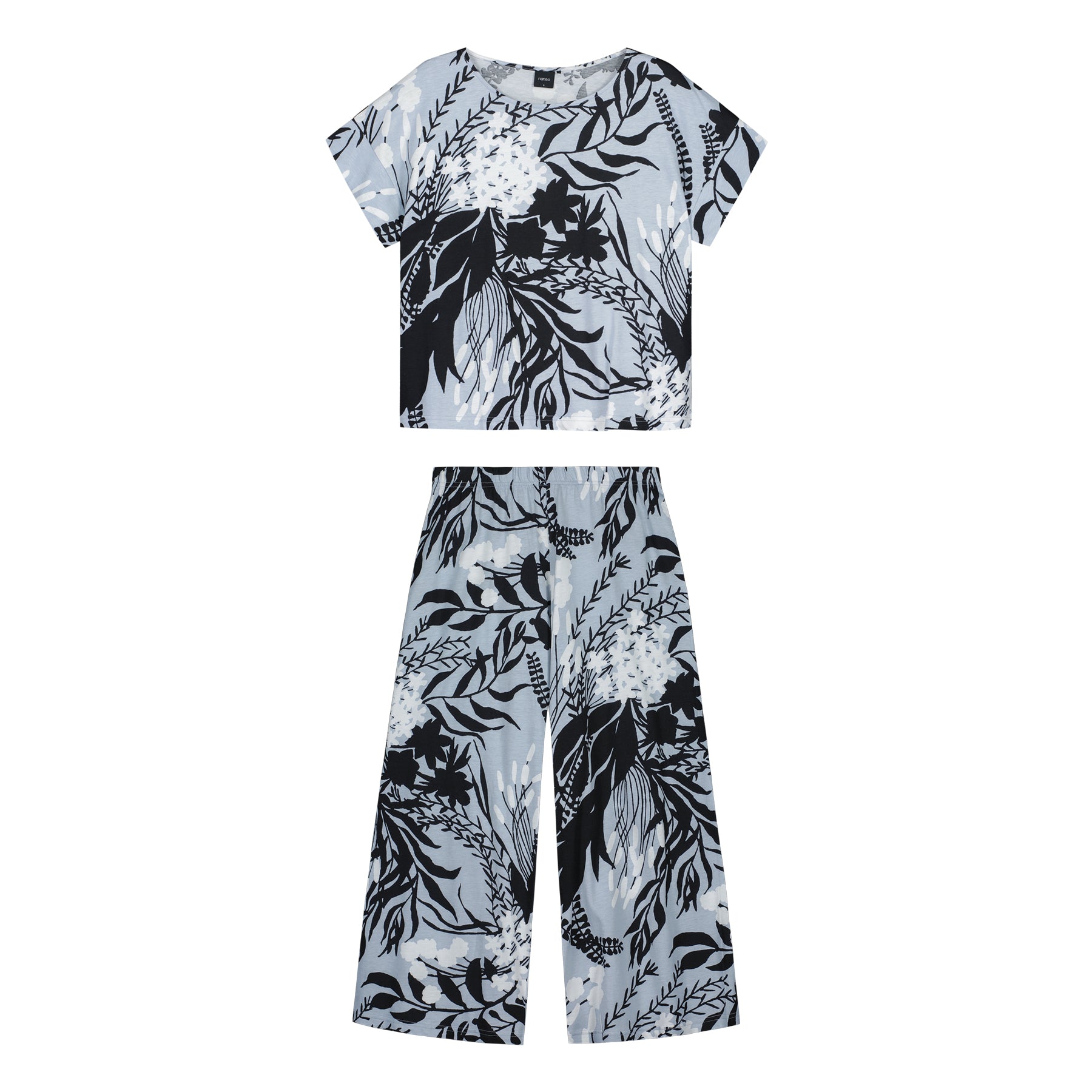 Flat lay of Nanso grey cotton pyjama set with short-sleeve top and cropped pants in black-and-white floral print