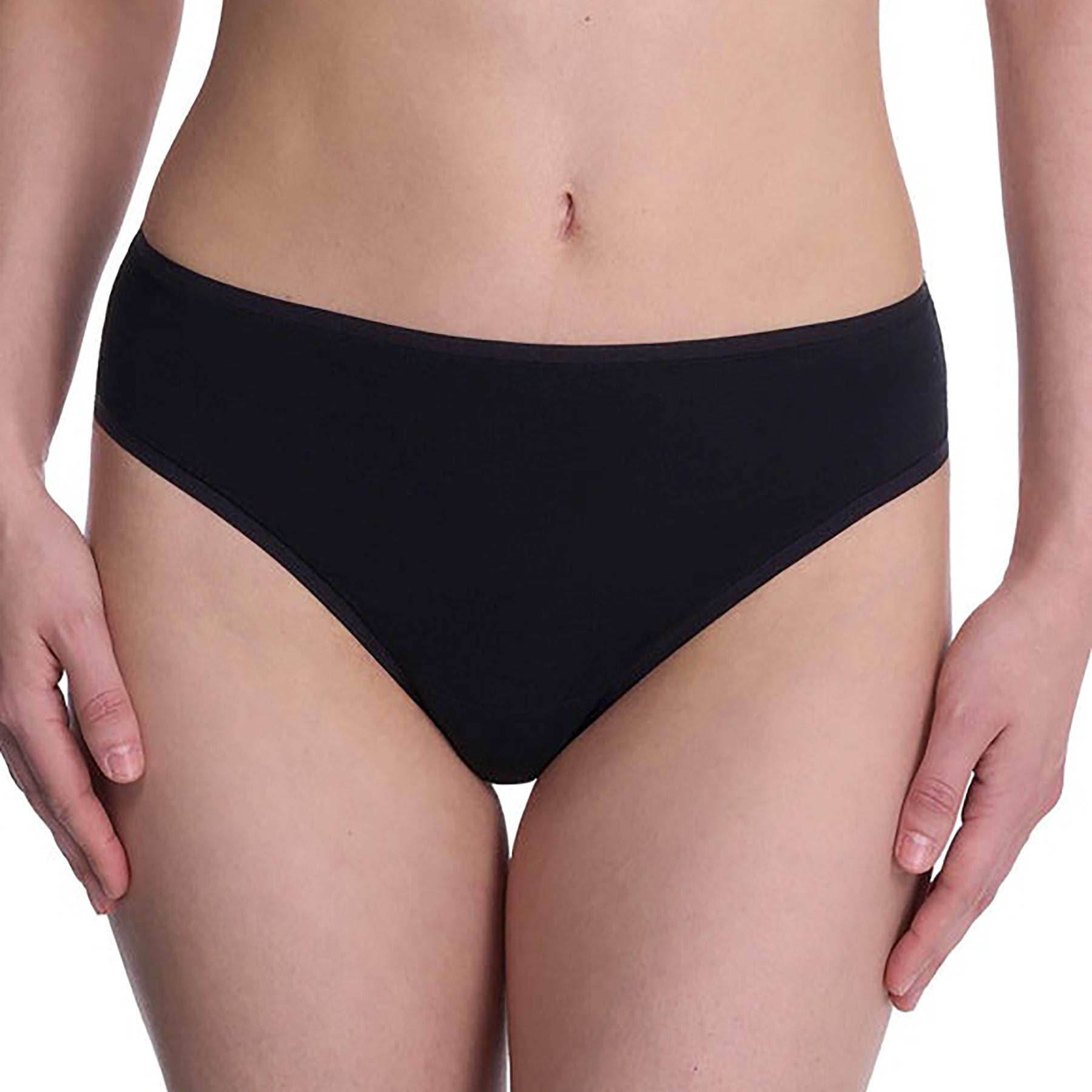 Seamless pima cotton mid-rise thong in black. Front view close up on model.