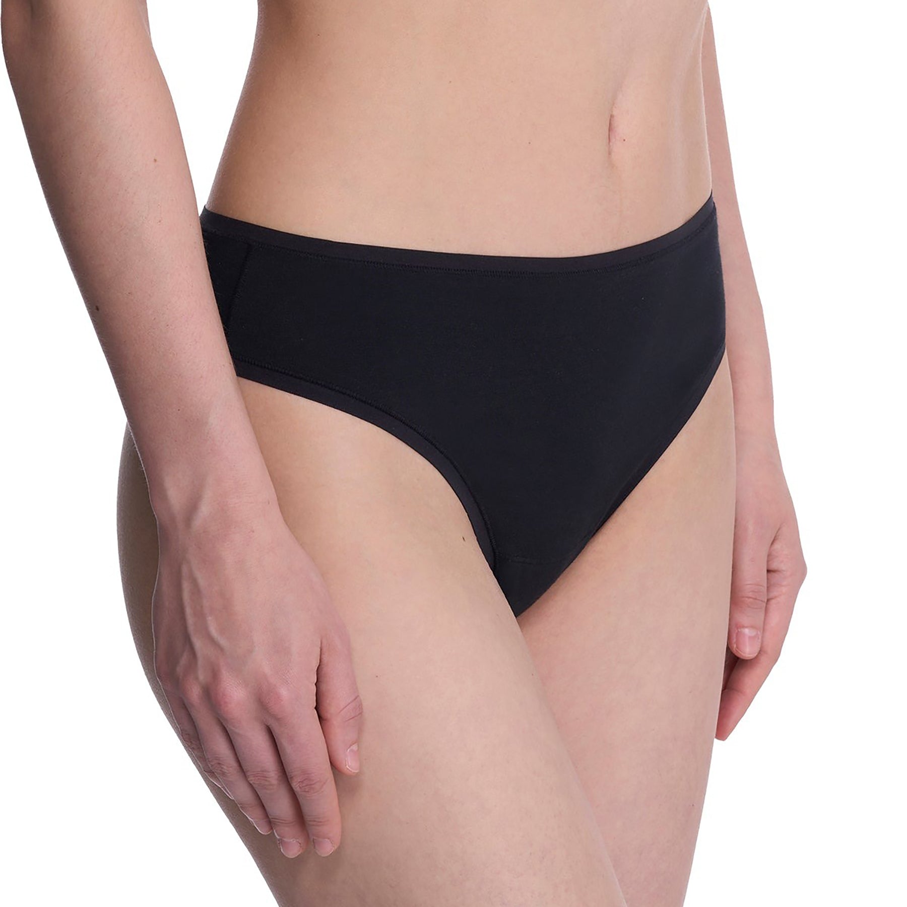 Seamless pima cotton mid-rise thong in black. Side view on model.