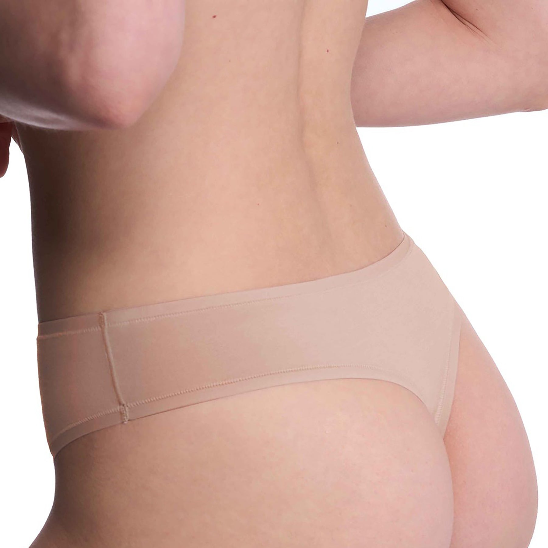 Seamless pima cotton mid-rise thong in cafe nude. Rear view close up on model.