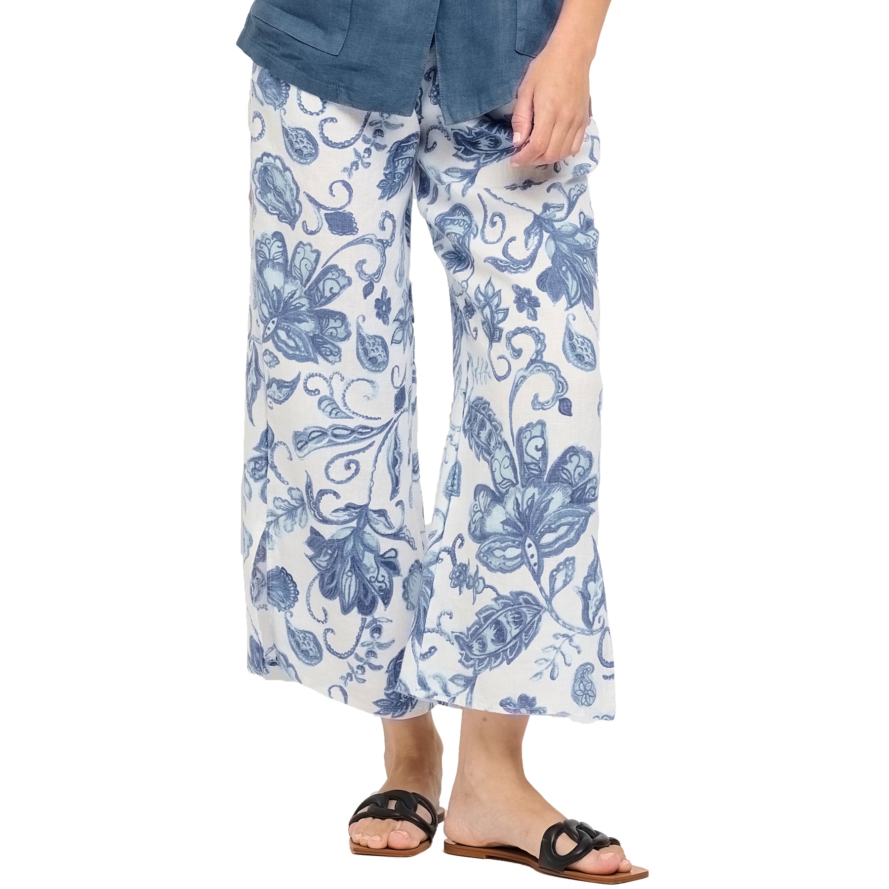 Azure summer print blue floral linen pants with split leg hem. Front view close up on model. 