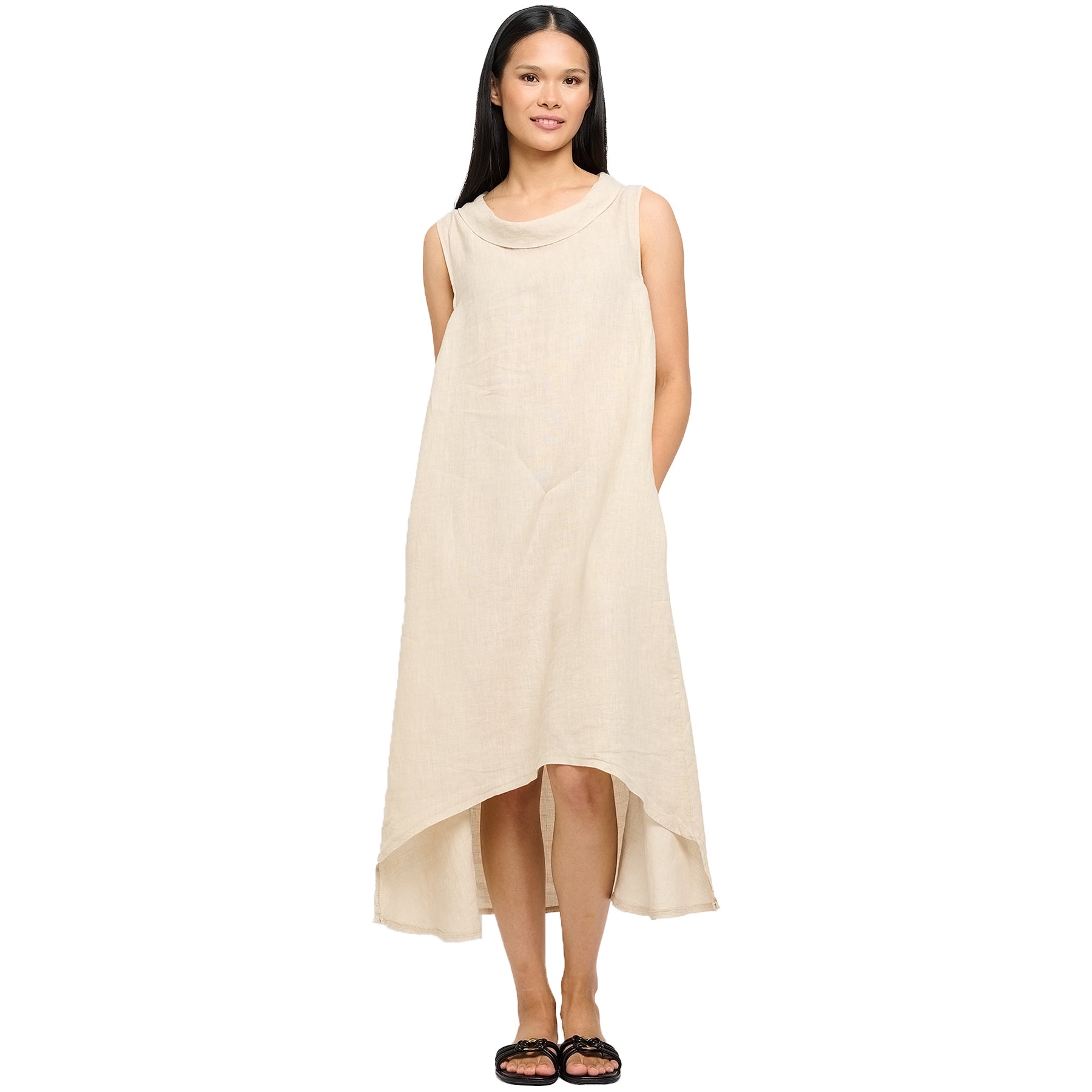 Full-length view of woman in a sleeveless high-low hem linen dress with a cowl neckline in soft sand tone - breezy and elegant warm-weather style.