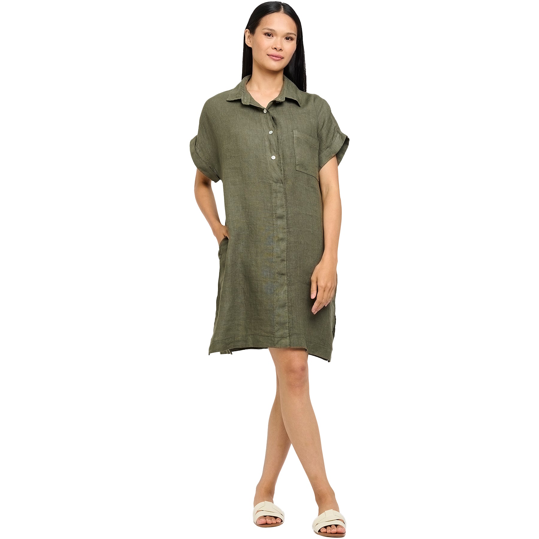 Full view of woman in a green short button-up collared dress with cuffed sleeves and pockets - casual and breezy warm-weather outfit.