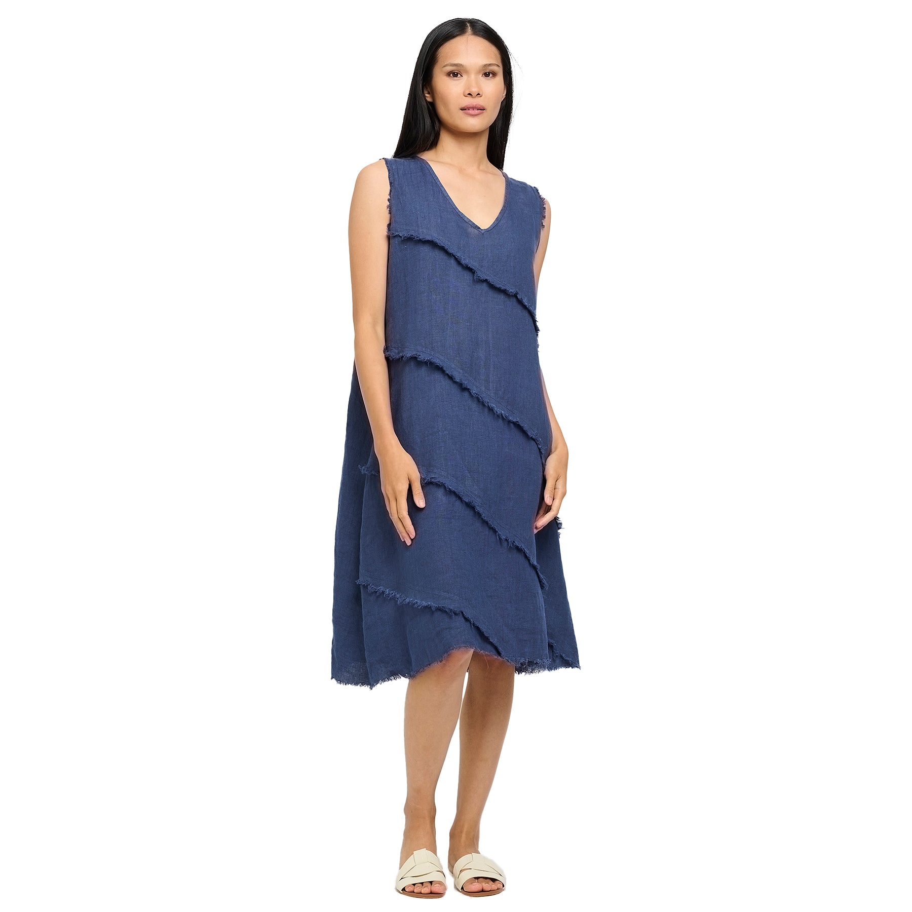 Woman wearing a navy sleeveless midi dress featuring V-neckline and layered fringe accents - relaxed and stylish warm-weather outfit.
