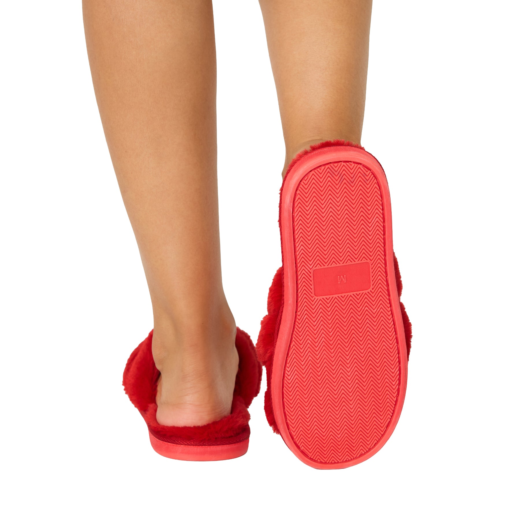 Red fuzzy crisscross slippers shown from the back with a close view of the textured non-slip sole.