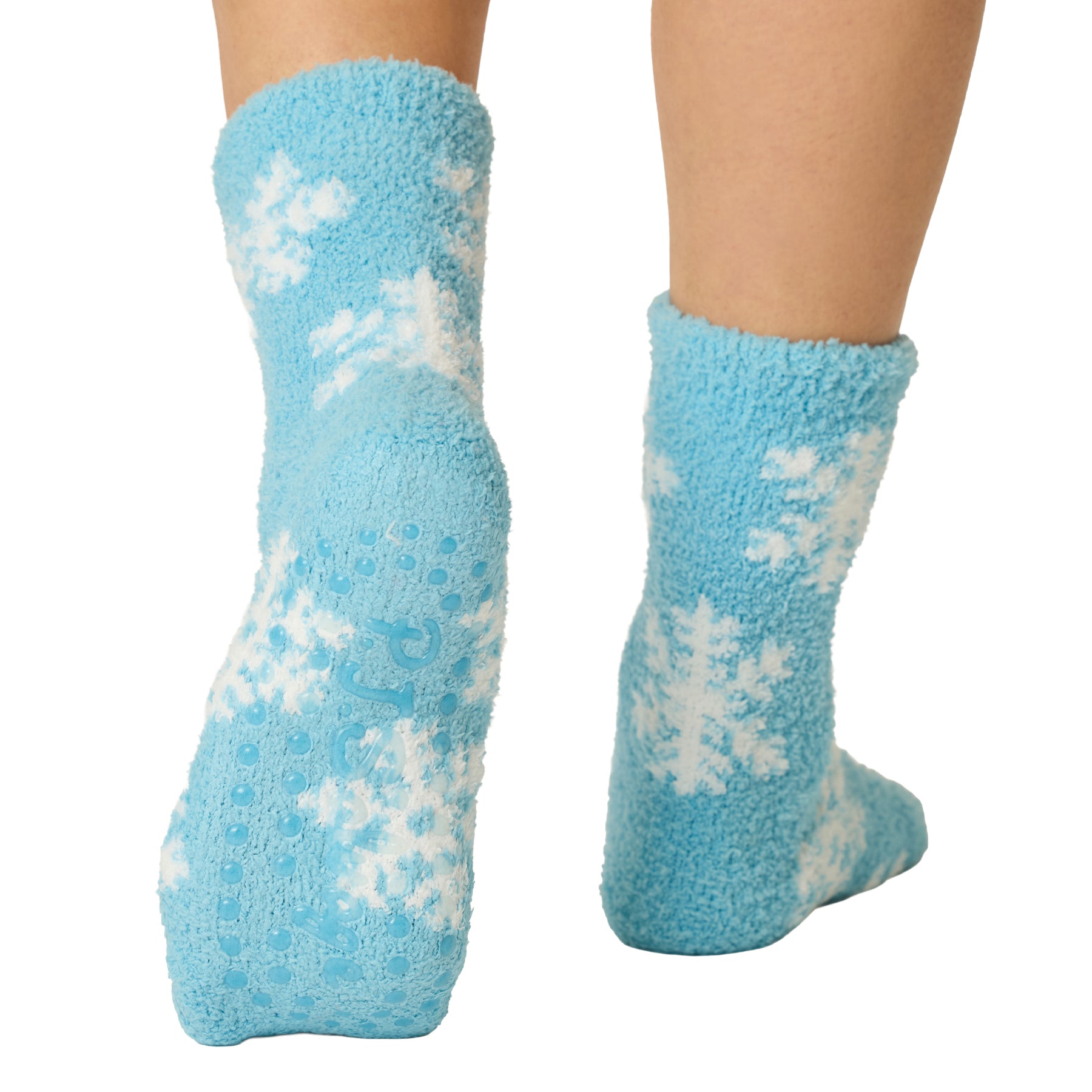 Back and sole view of blue snowflake socks showing non-slip grip dots for added traction.