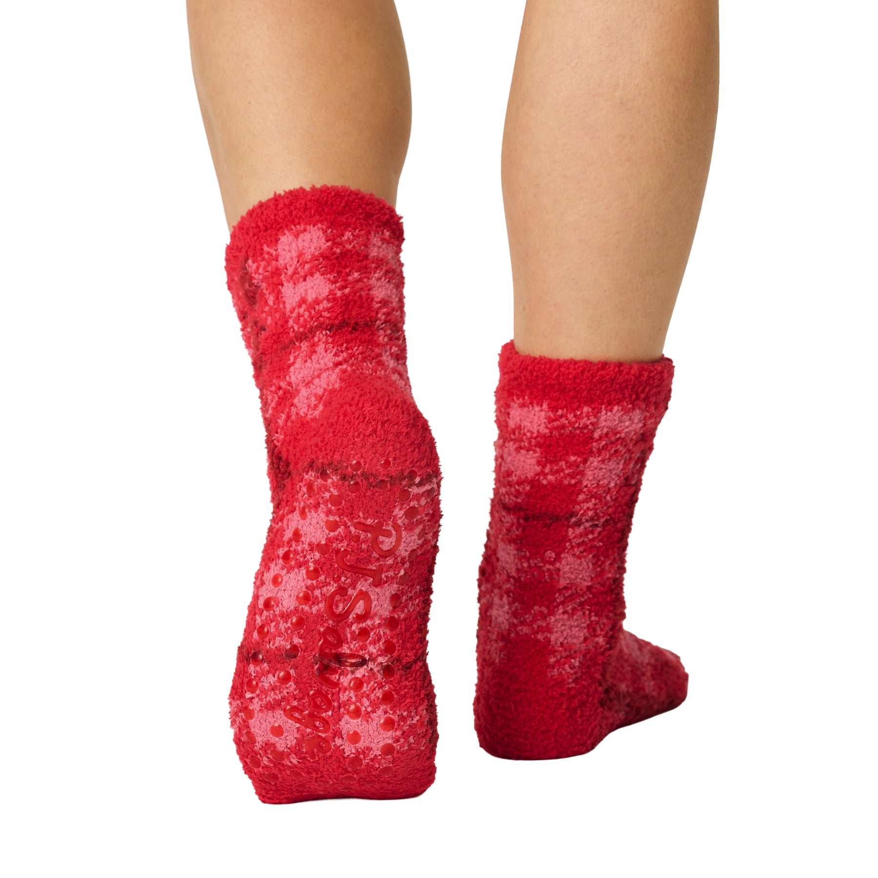 Back and sole view of red plaid fuzzy socks with non-slip grip dots for added traction.