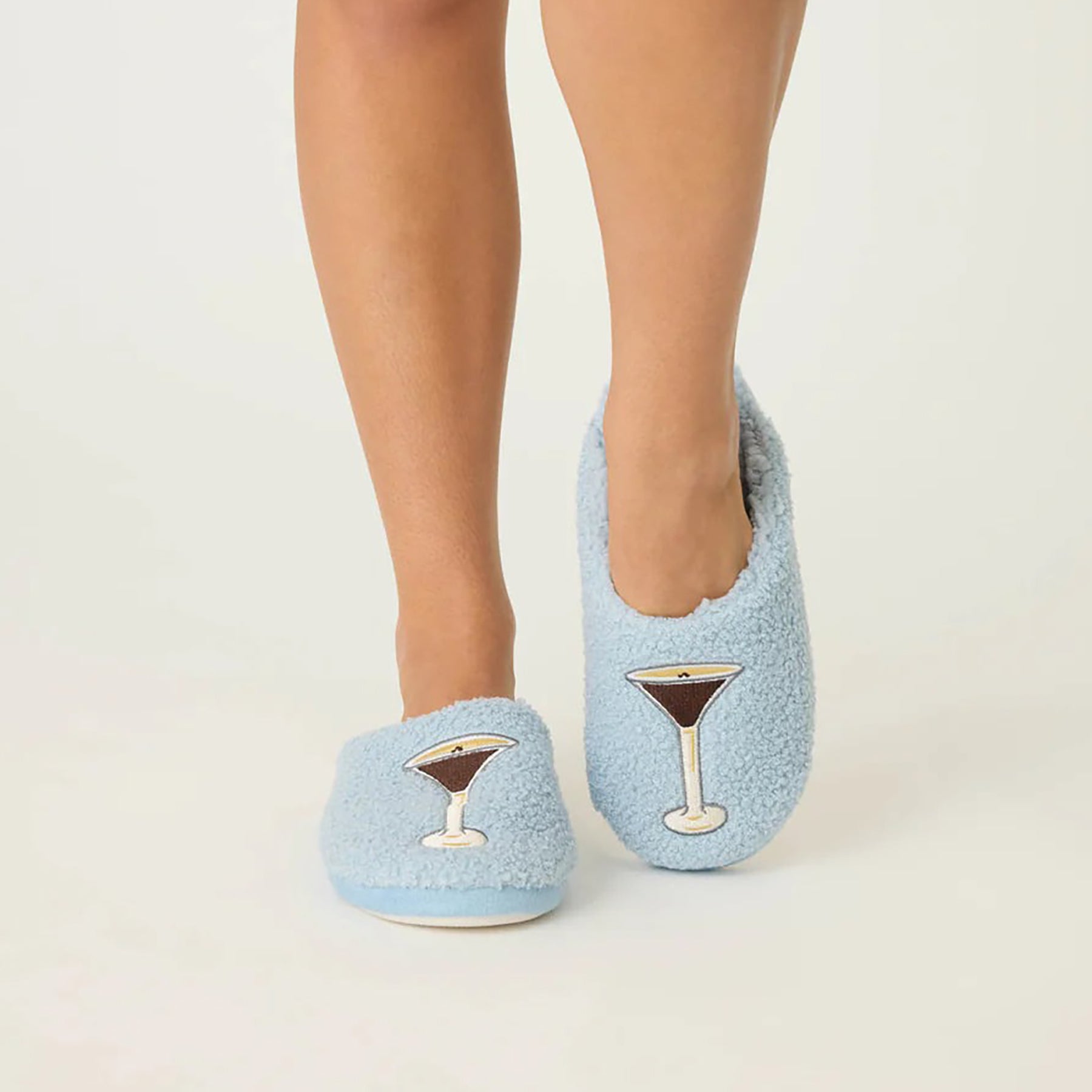 Fuzzy and fleecy slippers in bluestone with espresso martini print, front view.