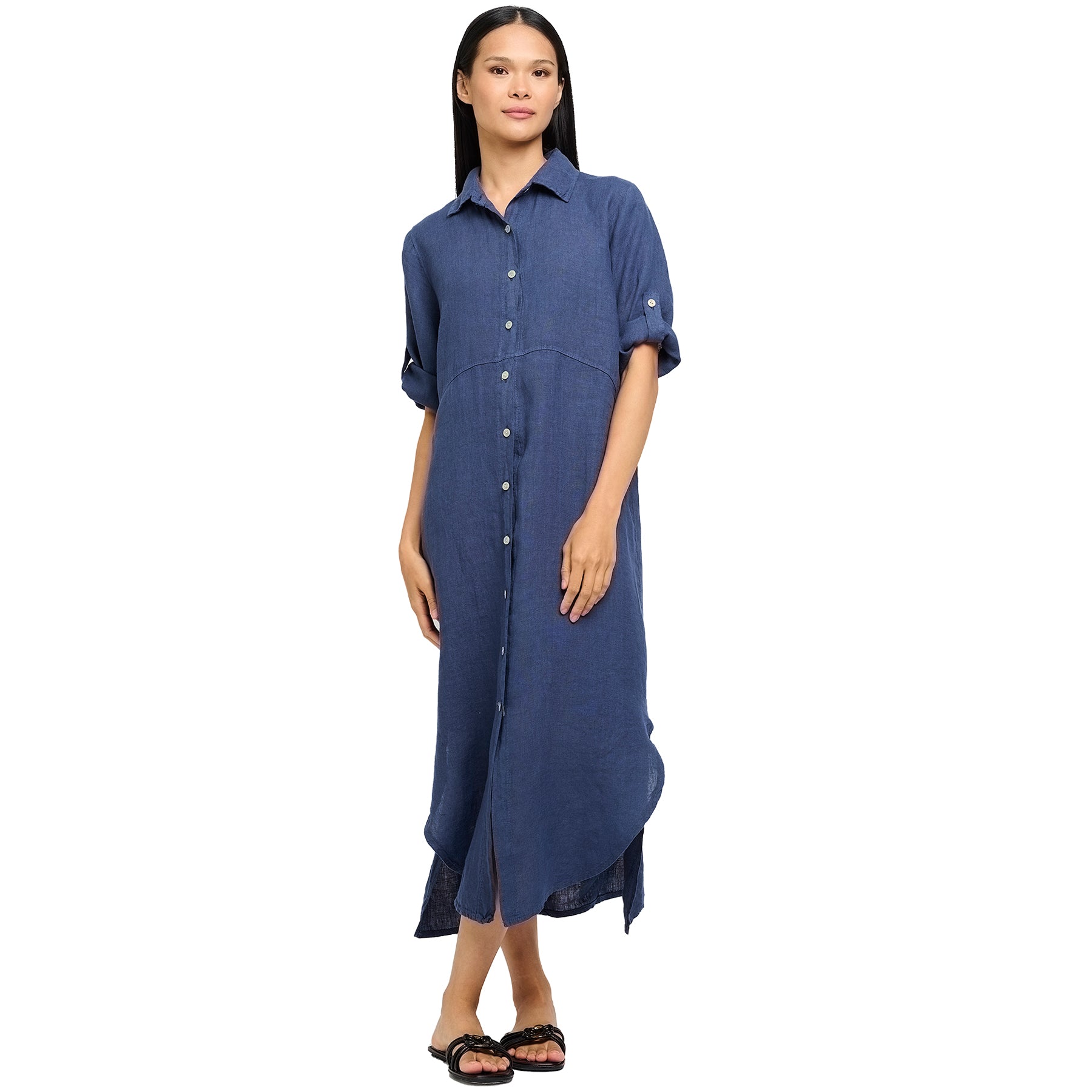 Long roll up sleeve button up linen dress in navy denim with rounded hem sides. Front view on model.