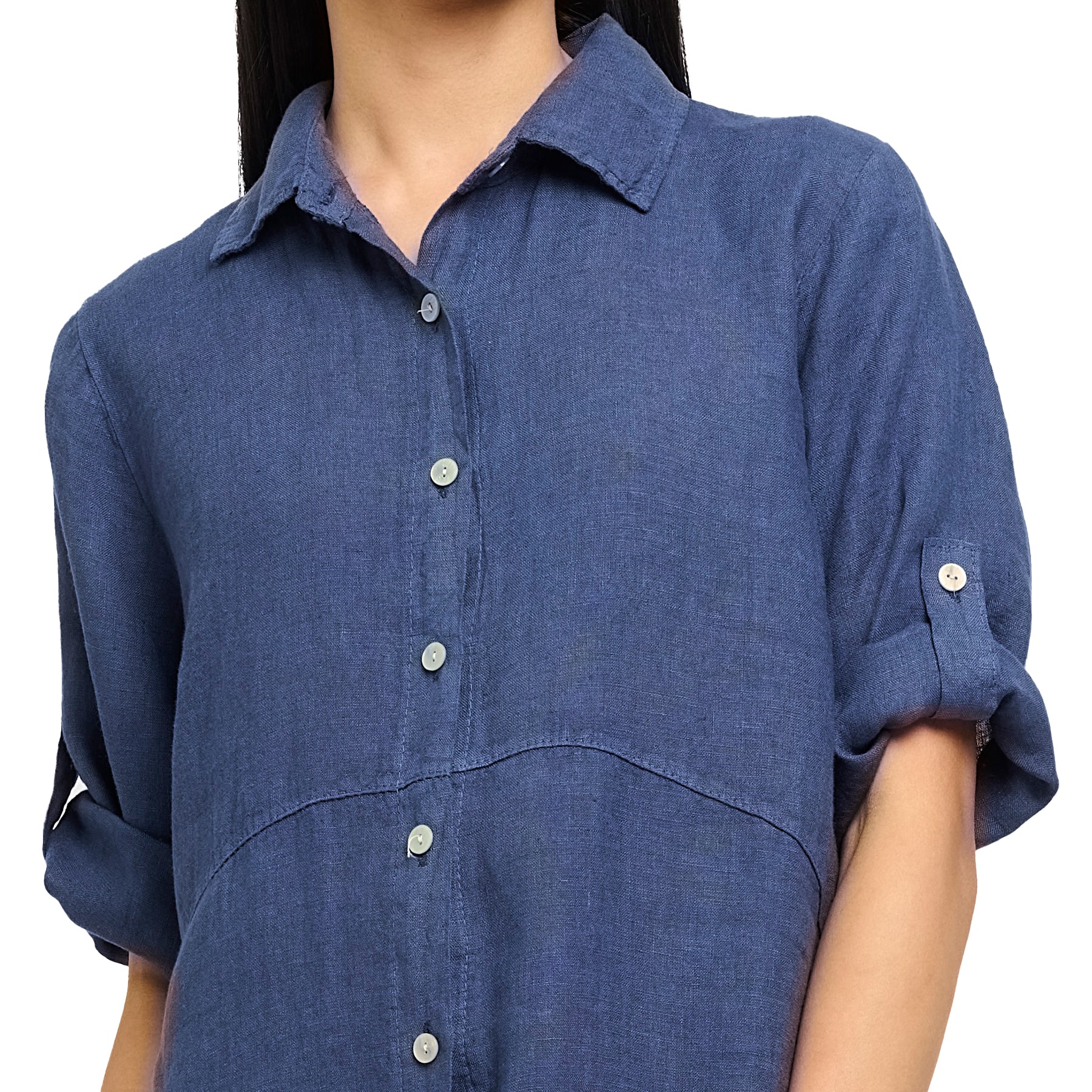 Long roll up sleeve button up linen dress in navy denim with rounded hem sides. Front view close up on model.