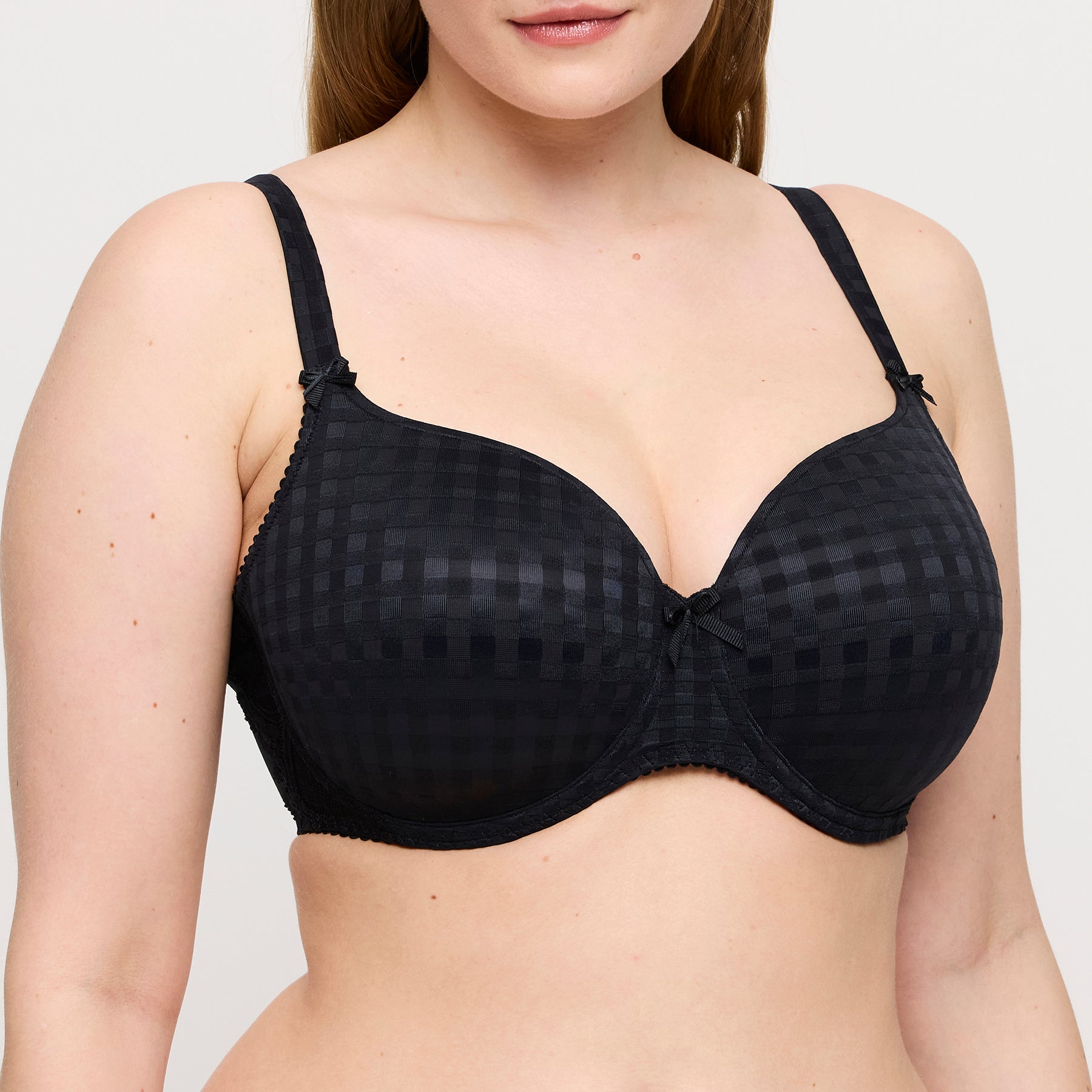 PrimaDonna Madison black padded heart bra on model highlighting lifted shaping, checked moulded cups, and feminine detailing.