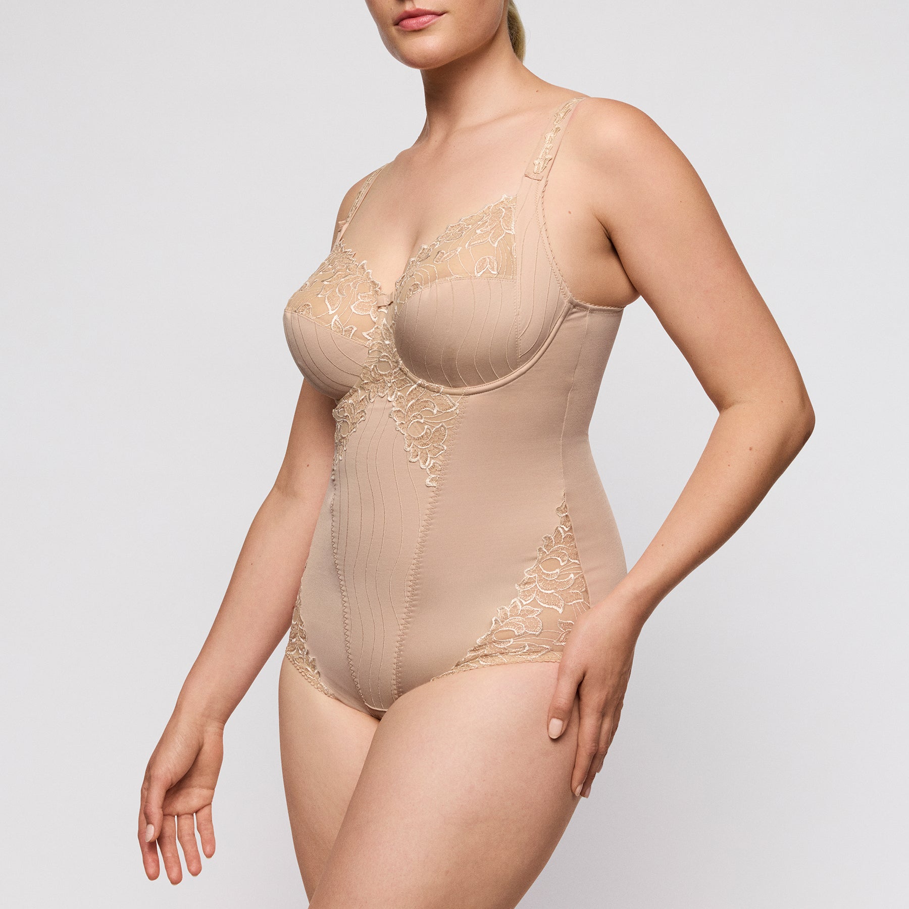 PrimaDonna Deauville underwired bodysuit style 046-1810 in caffé latte, elegant shaping bodysuit with lace detailing and smooth silhouette, angled front view on model