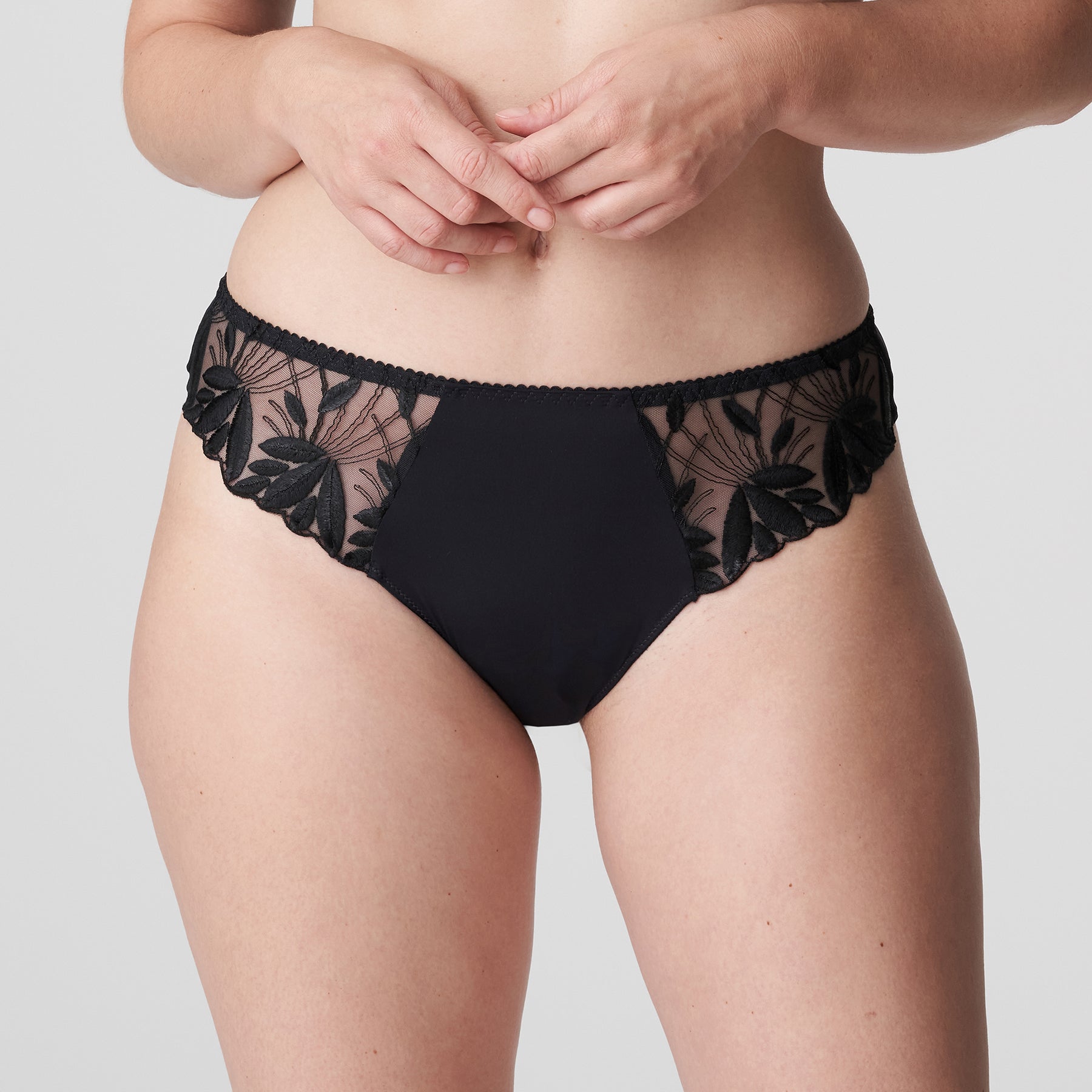 PrimaDonna Orlando charcoal grey thong with embroidery at the hips. Front view on model.