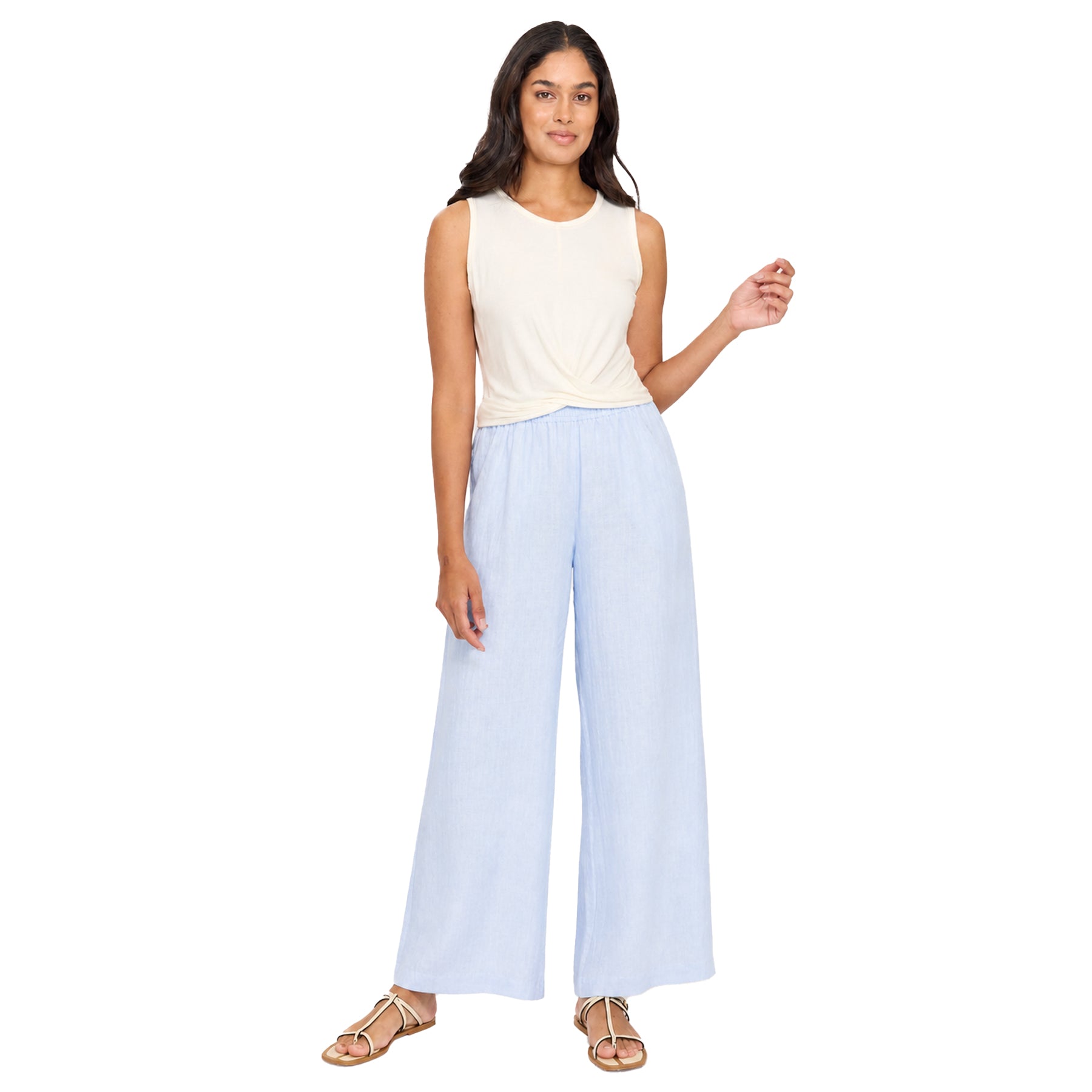 Light blue wide-leg pants on a model, styled with a sleeveless cream top, showcasing a loose fit and airy drape for an effortless, comfortable look.