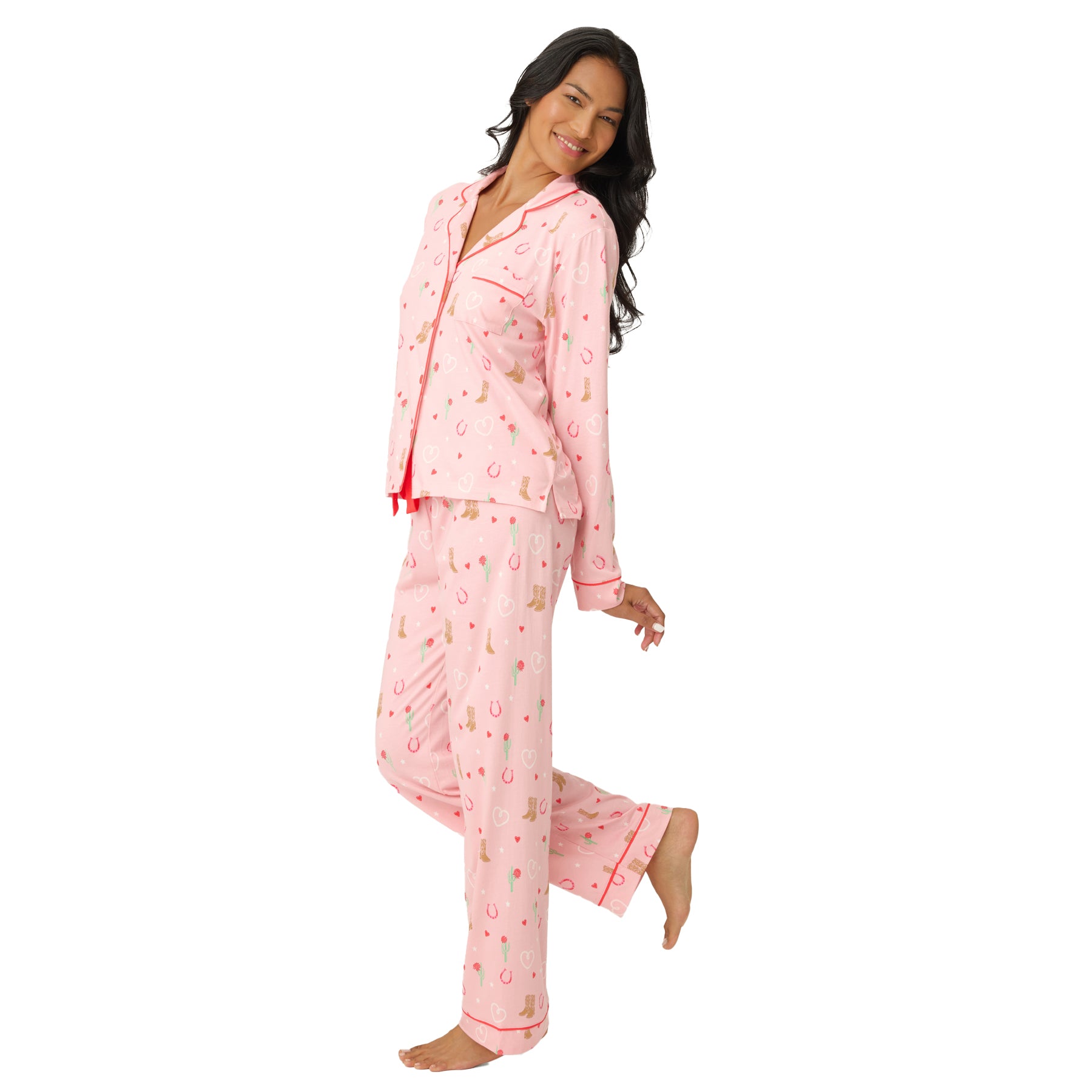 Side view of the pink printed pyjama set highlighting the relaxed fit and full-length pants, worn by a model on a white background.
