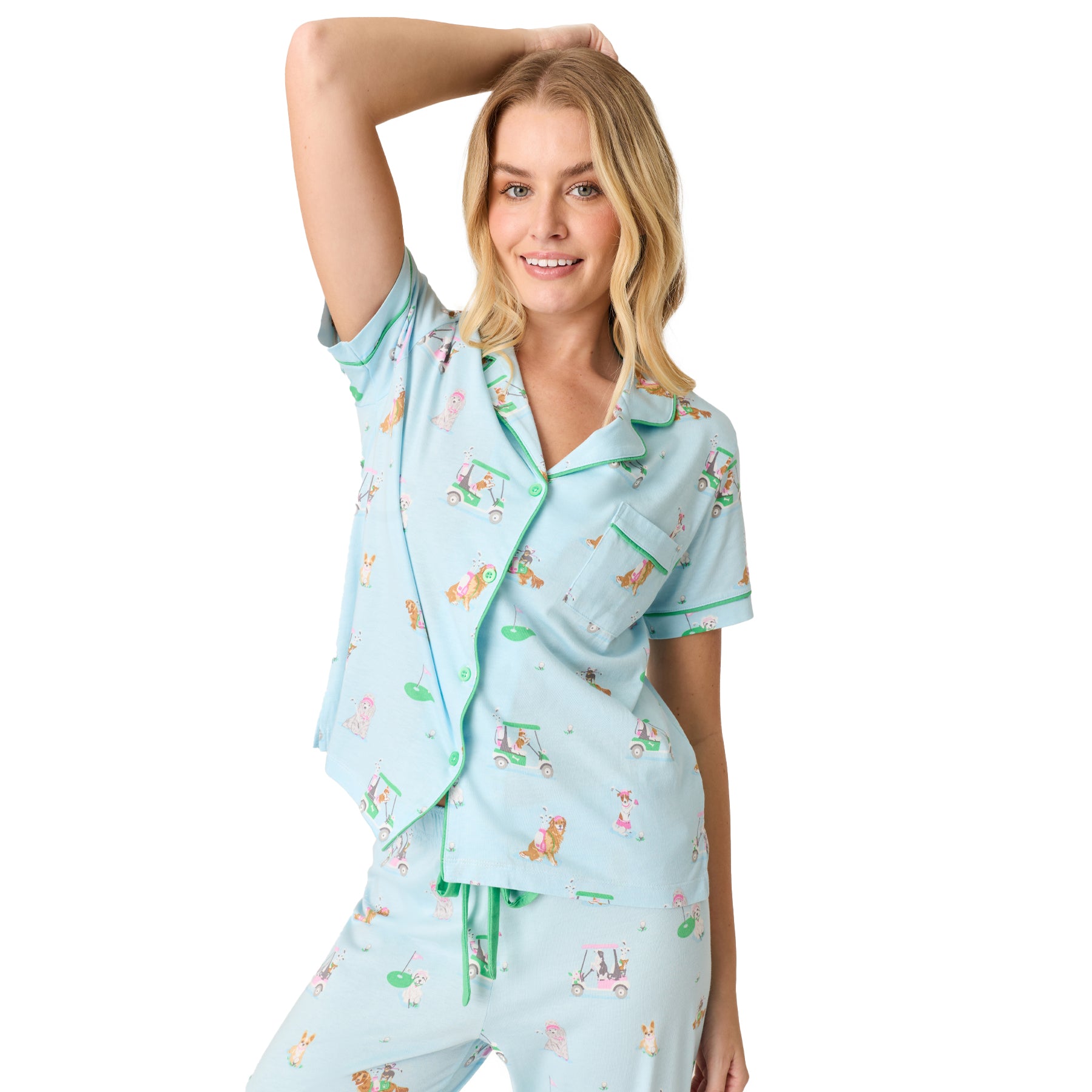 Light blue women’s pyjama set with green piping and playful dog print, model posing front view