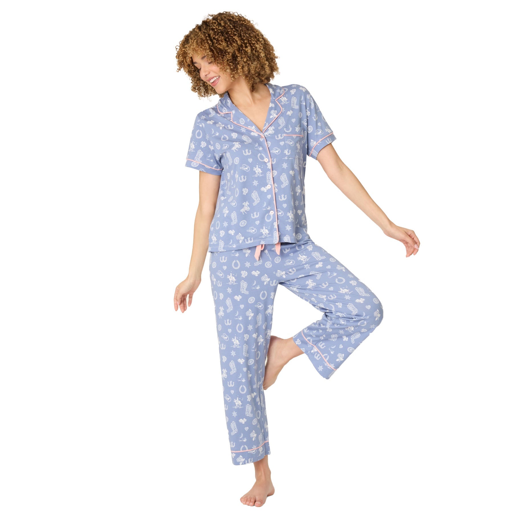 Light blue women’s button-front pyjama set with western print and pink piping, front view