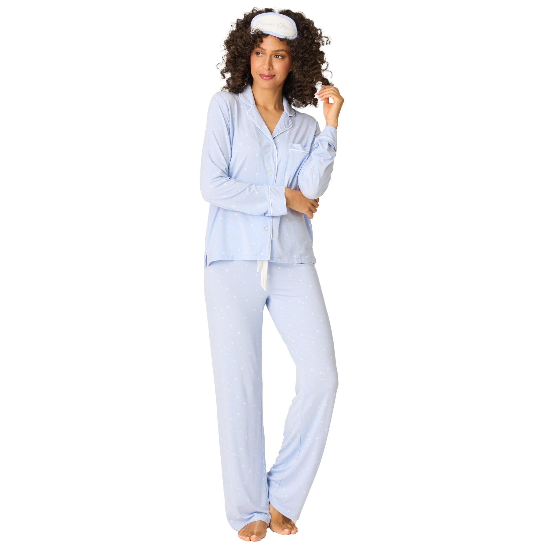 Women’s baby blue long sleeve pyjama set with button-up top and matching pants, white star print and sleep mask