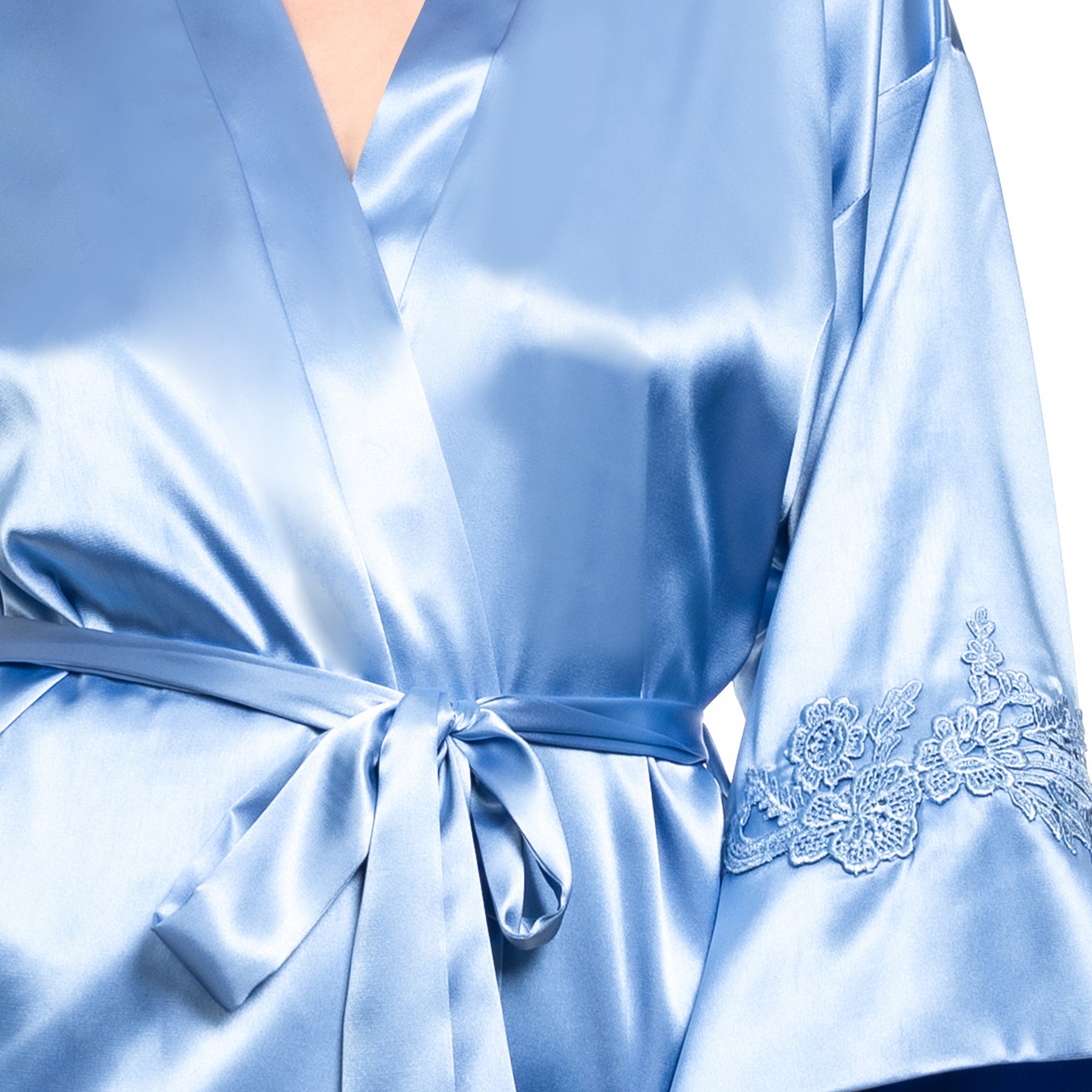 Close-up of cornflower blue satin robe showing waist tie and delicate embroidered lace sleeve detail.