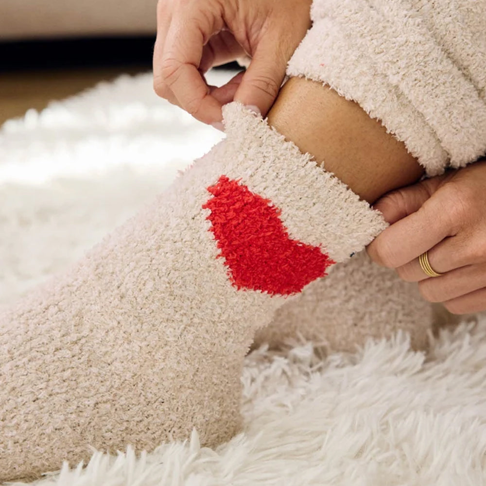 Close-up of Splendid Oat Heather Hearts fuzzy crew socks featuring a bright red heart design, plush oatmeal fabric, and a soft, stretchy cuff.