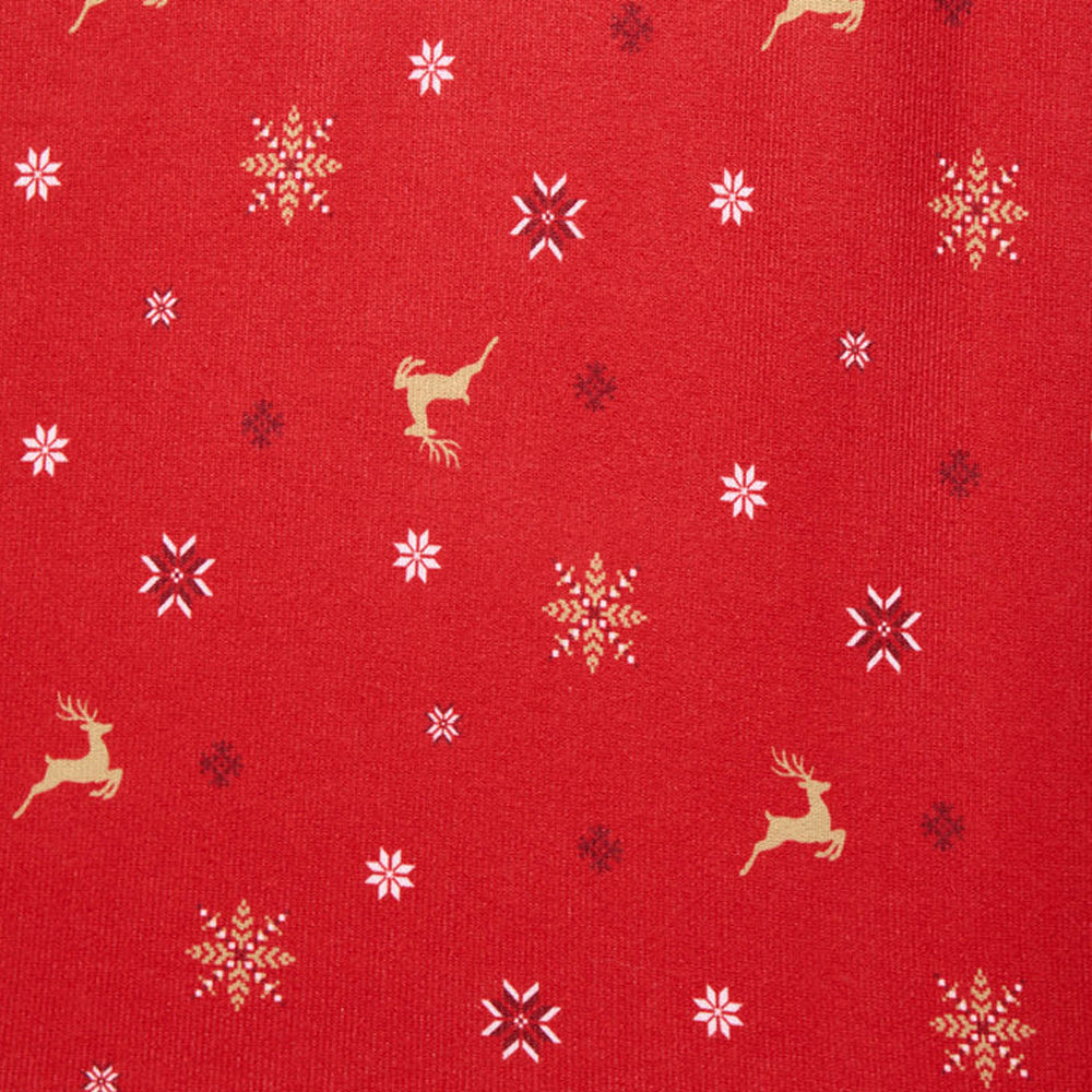 Close-up of Splendid Pillowsoft red Christmas pajama fabric featuring gold reindeer and white, gold, and dark snowflakes.