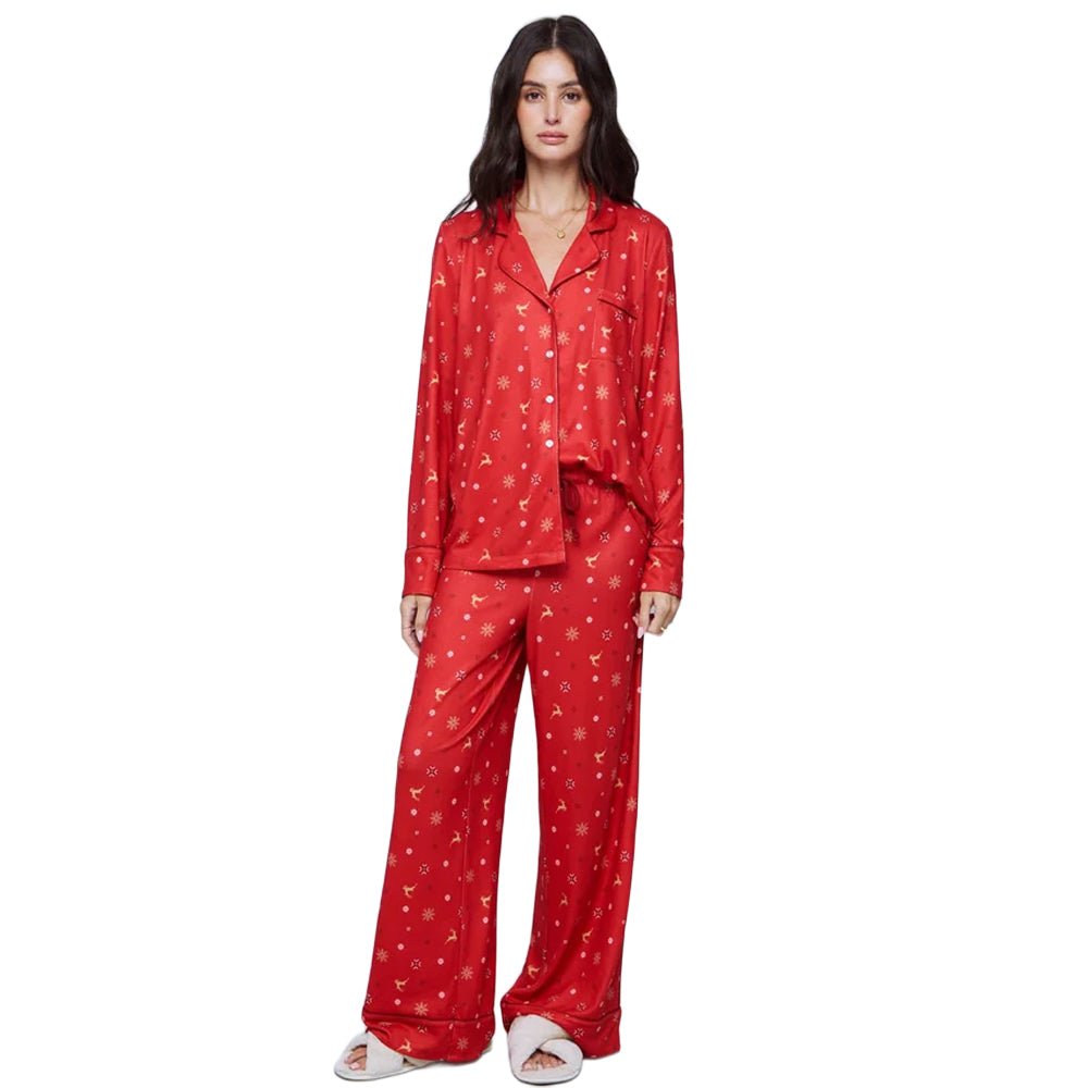 Model wearing Splendid Pillowsoft women's red holiday PJ set with long-sleeve button-up shirt, relaxed wide-leg pants, and festive reindeer print.