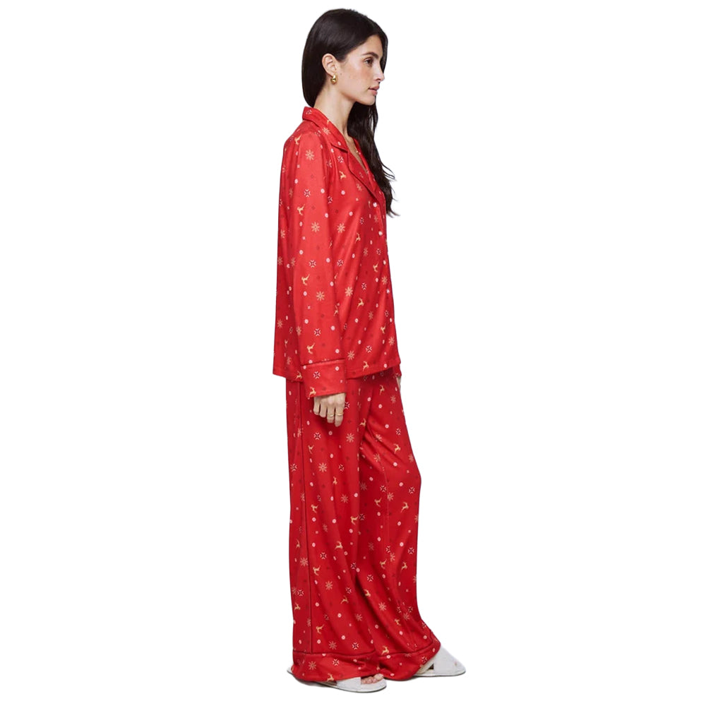 Side view of Splendid Pillowsoft red Christmas pajama set featuring a relaxed long-sleeve top and matching full-length pants with reindeer and snowflake print.