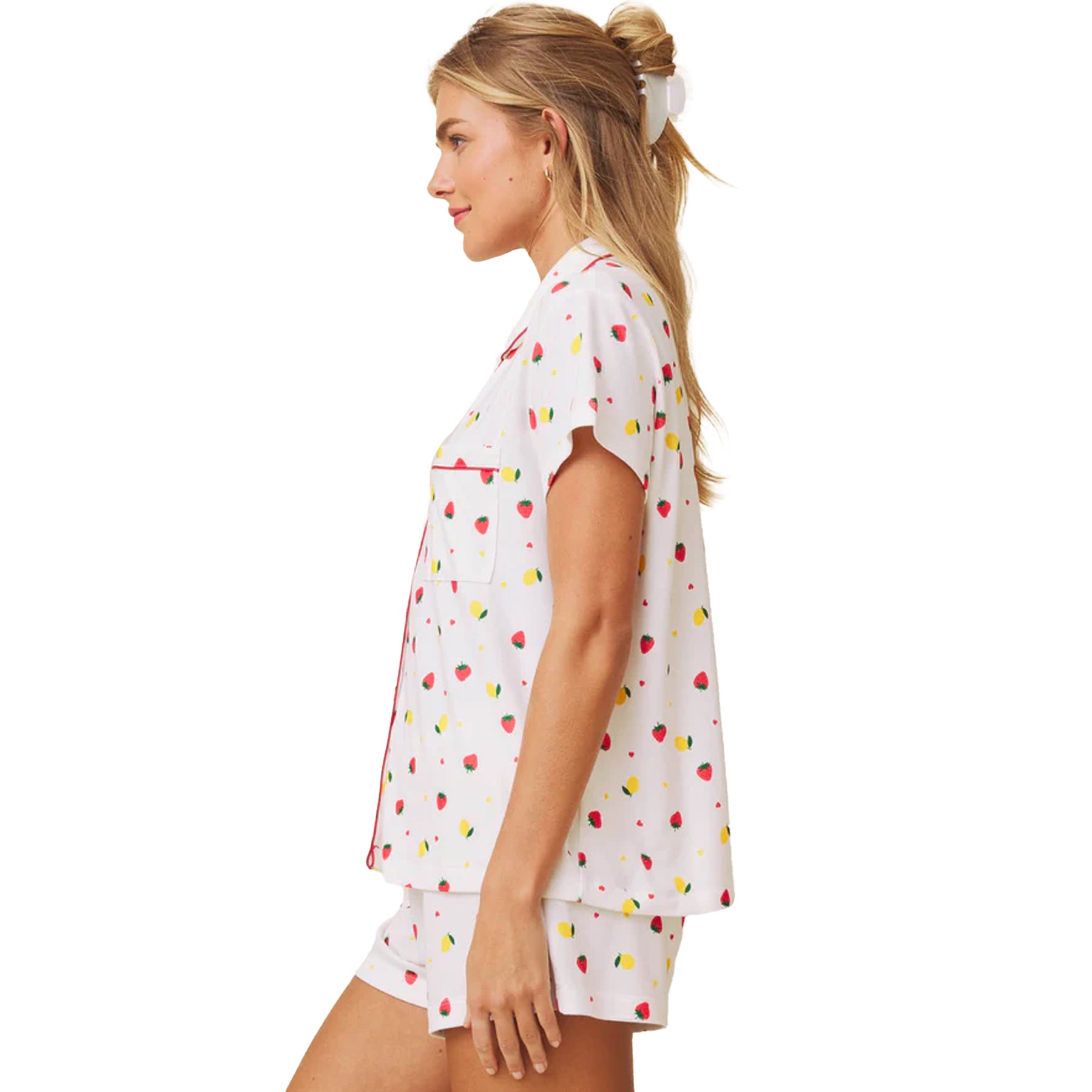 Side profile of white printed short sleeve pyjama set with button-up top and contrast piping