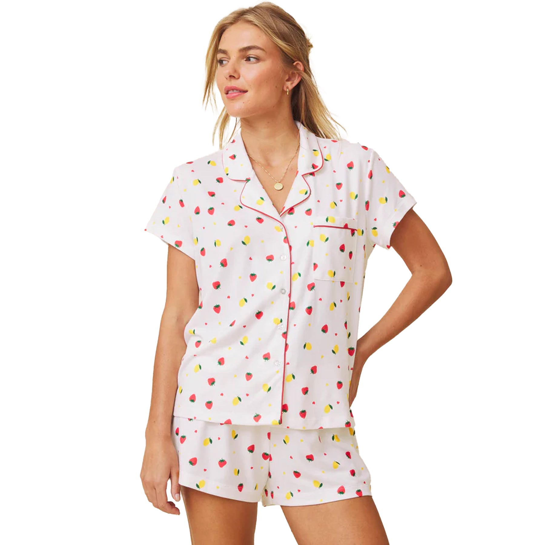 Front view of white short sleeve pyjama set with button-down top, chest pocket, and fruit print