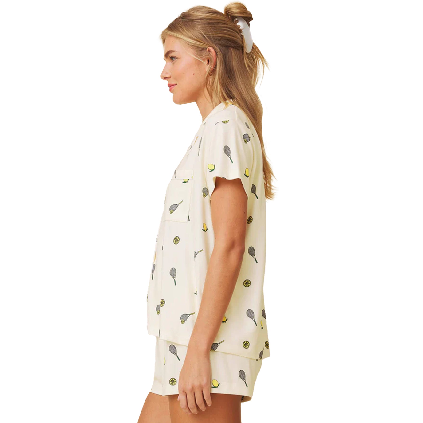 Side profile of yellow printed short sleeve pyjama set with button-up top and relaxed shorts