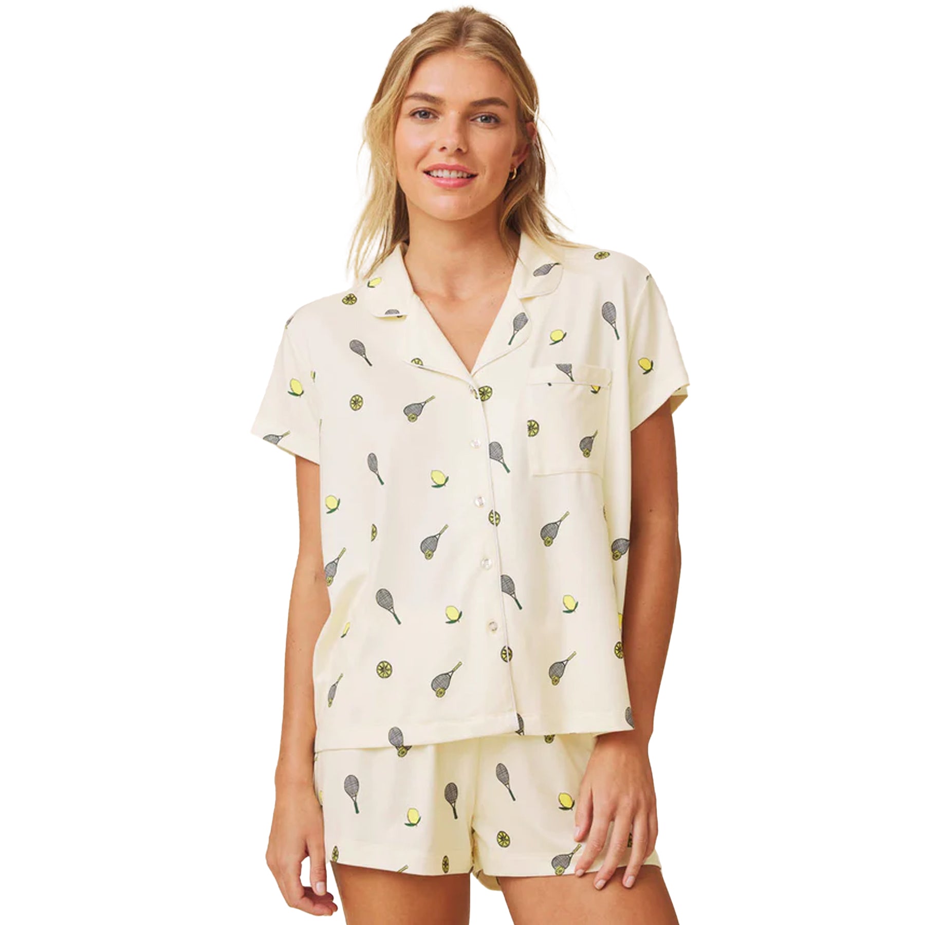 Front view of pale yellow short sleeve pyjama set with lemon and tennis print and chest pocket