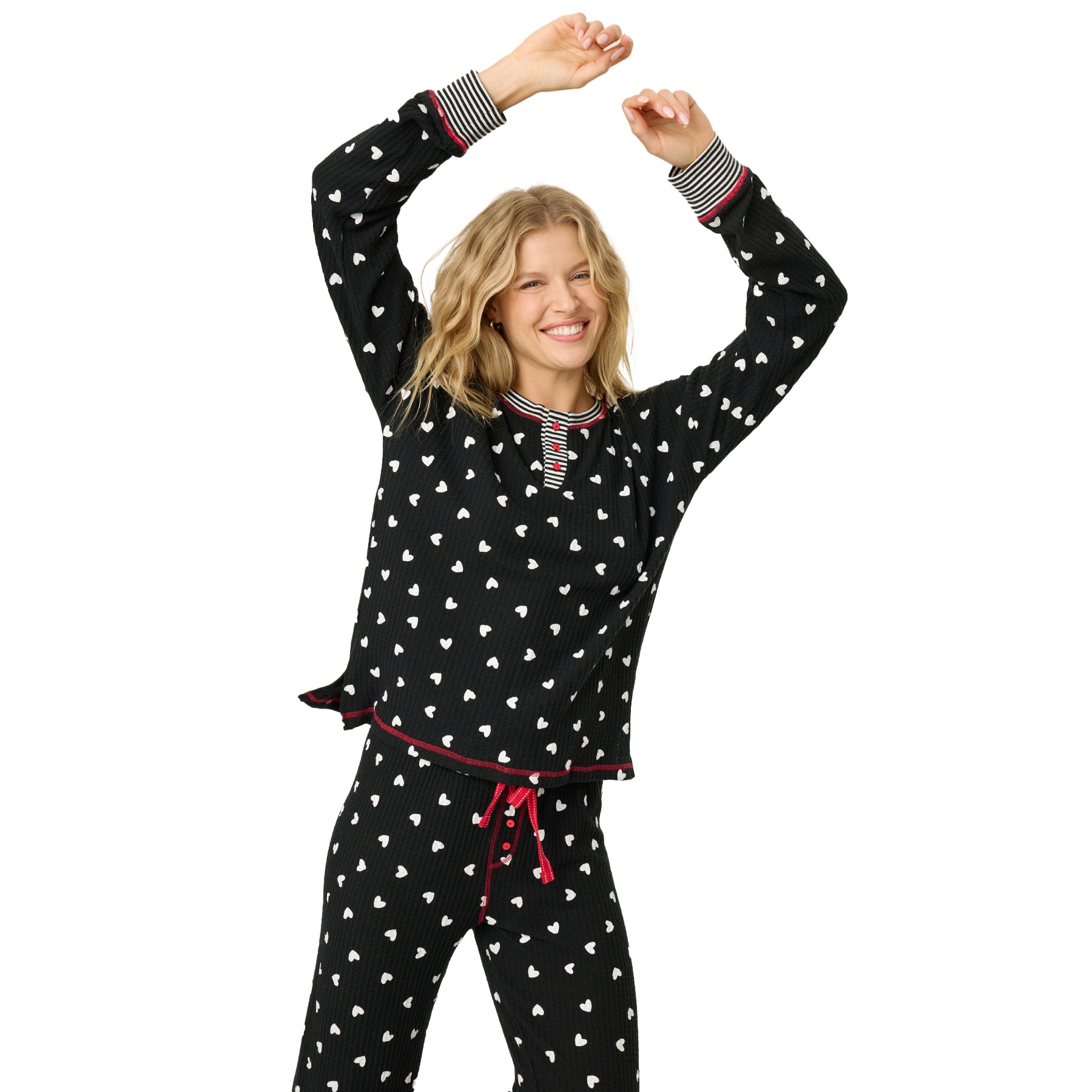 A model wearing black printed pajamas creating a swing with her hands.