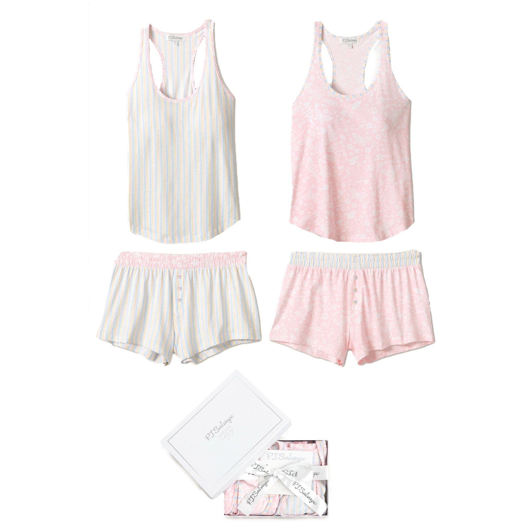 A flat lay of two pajama sets, one in pastel pink with floral details and the other with blue and yellow stripes, along with the branded gift box.