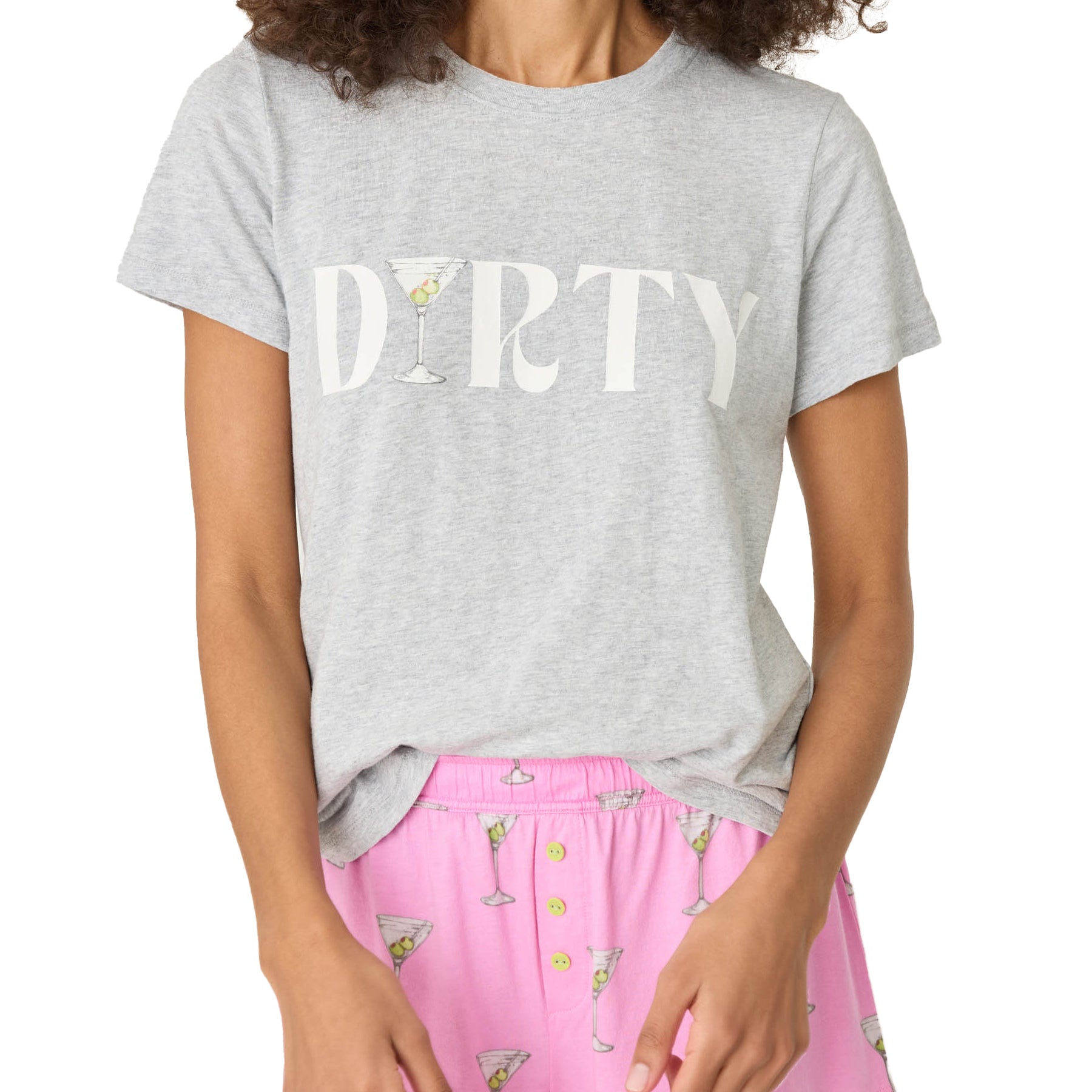 A close-up of a gray T-shirt with the word "DIRTY" printed in bold letters, incorporating a martini glass graphic, paired with pink martini-print pajama shorts.