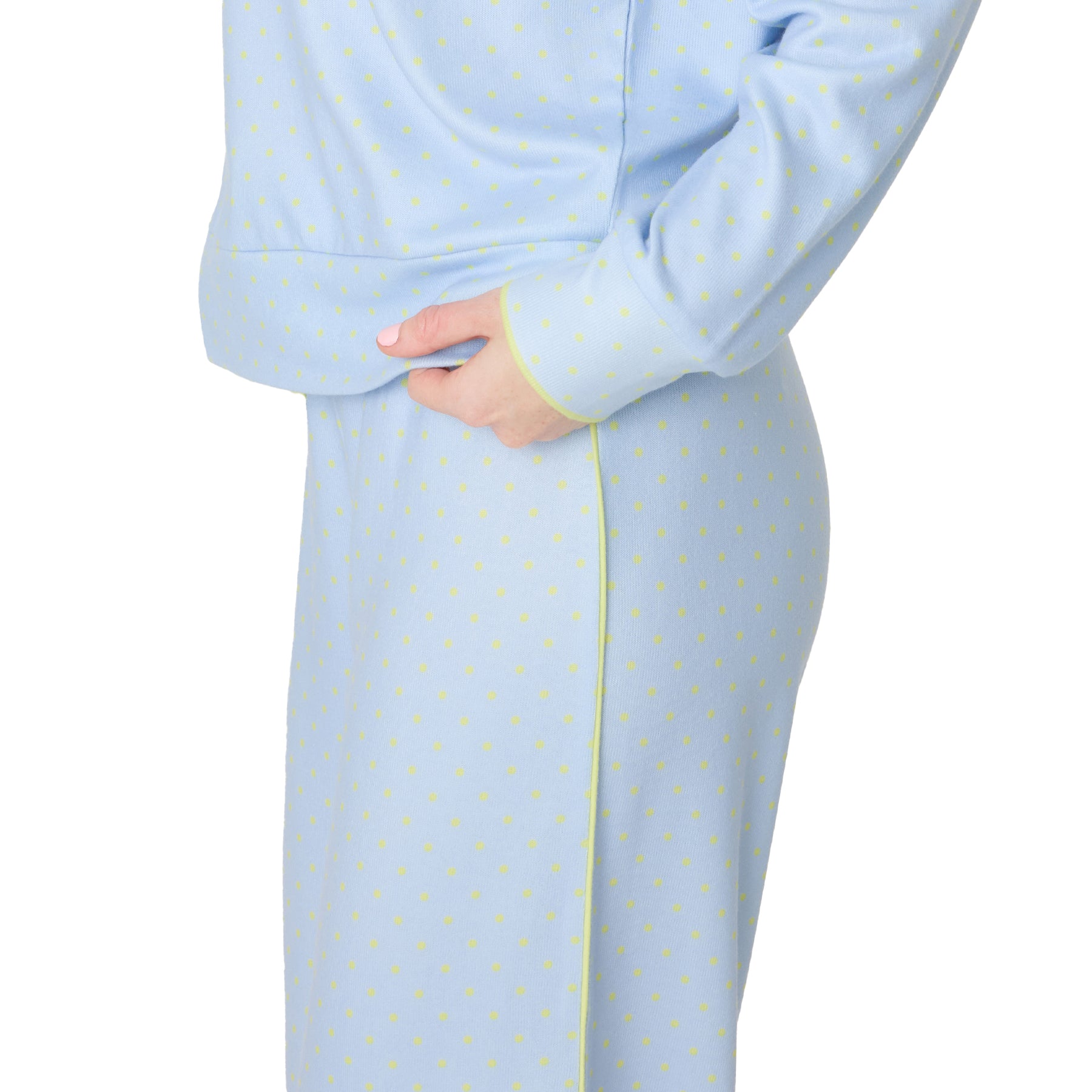 Close-up side view of light blue pajama set with yellow polka dots and piping detail.