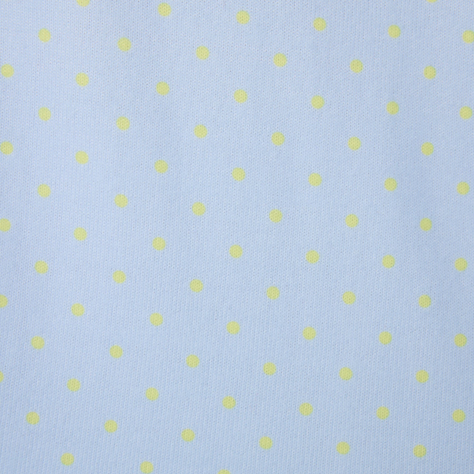 Fabric close-up showing light blue material with yellow polka dot print.