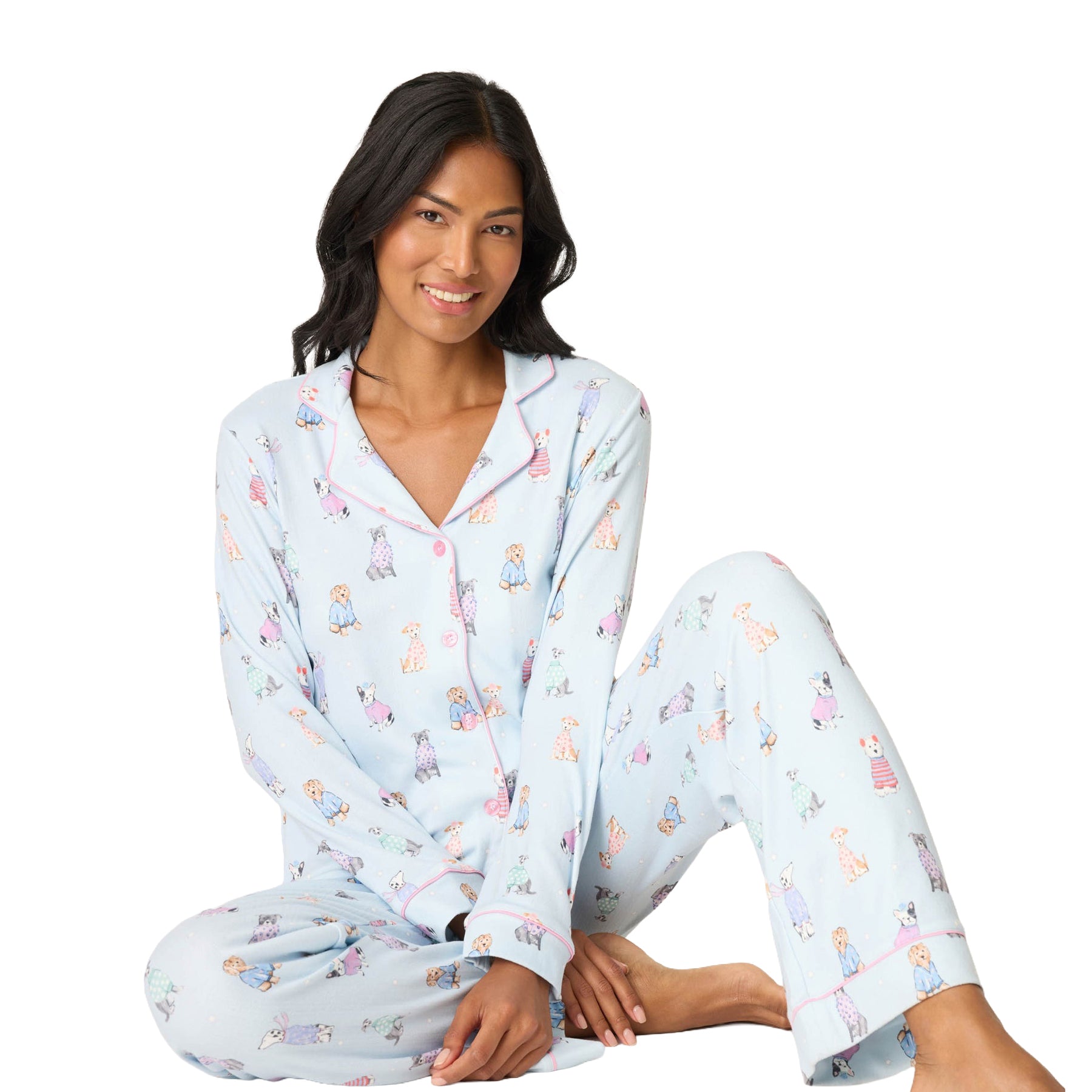 Woman wearing light blue pajamas with a pattern of small figures on a white background