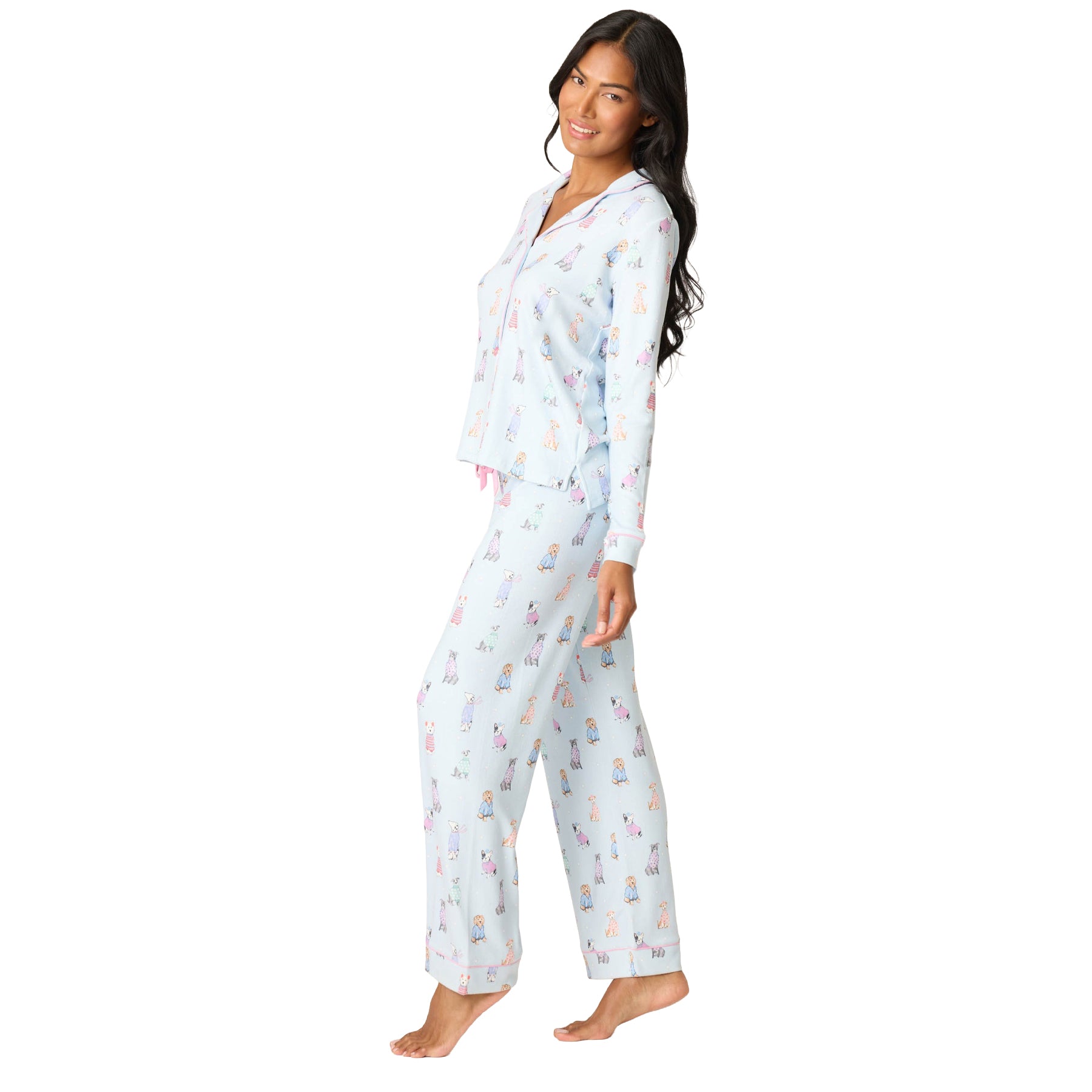 Woman wearing a light blue pajama set with animal pattern on a white background