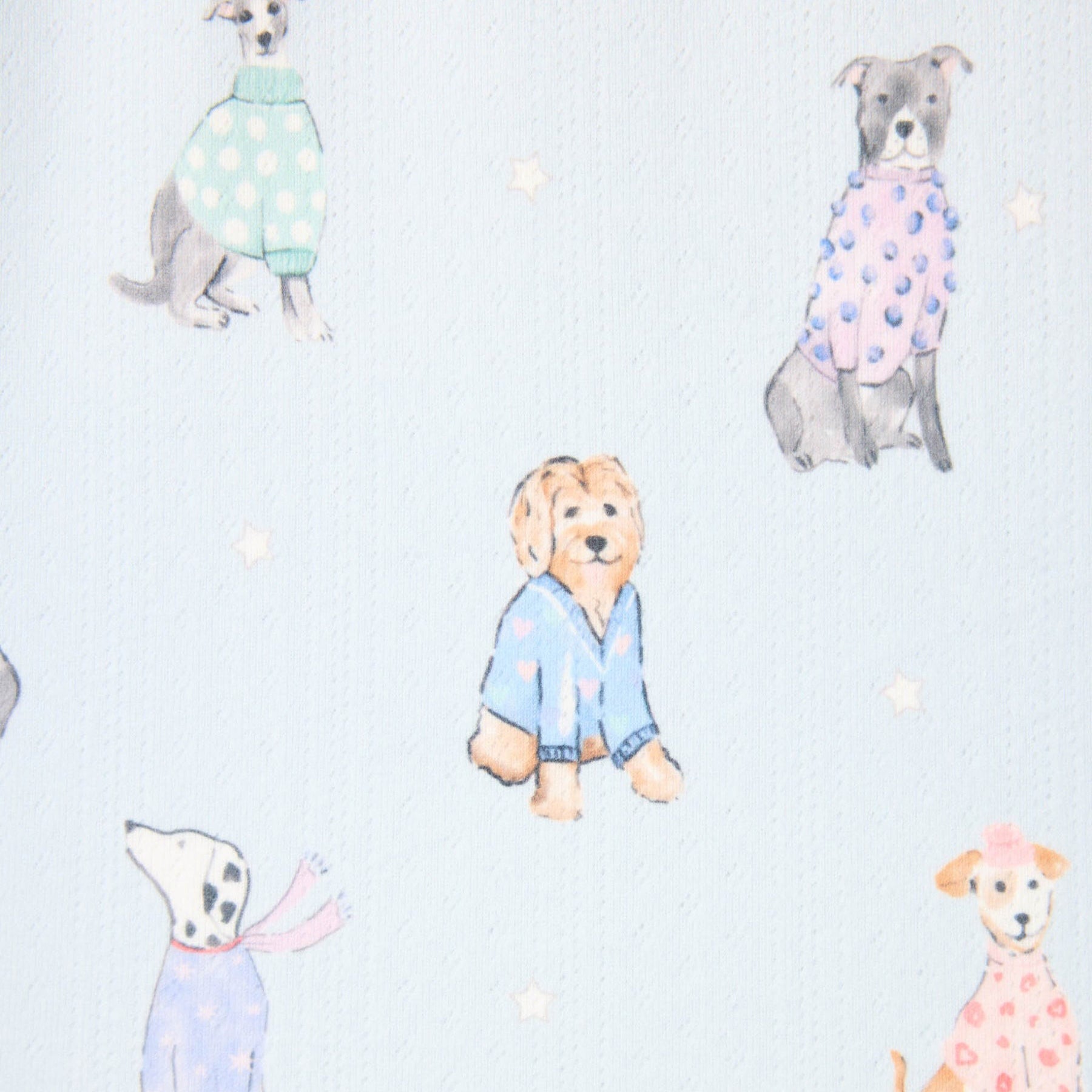 Pattern of dogs in colorful outfits on a light blue background