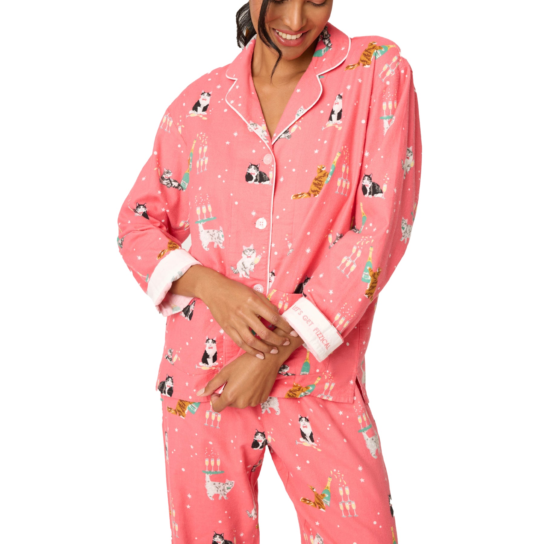Woman wearing pink pajamas with animal print on a white background