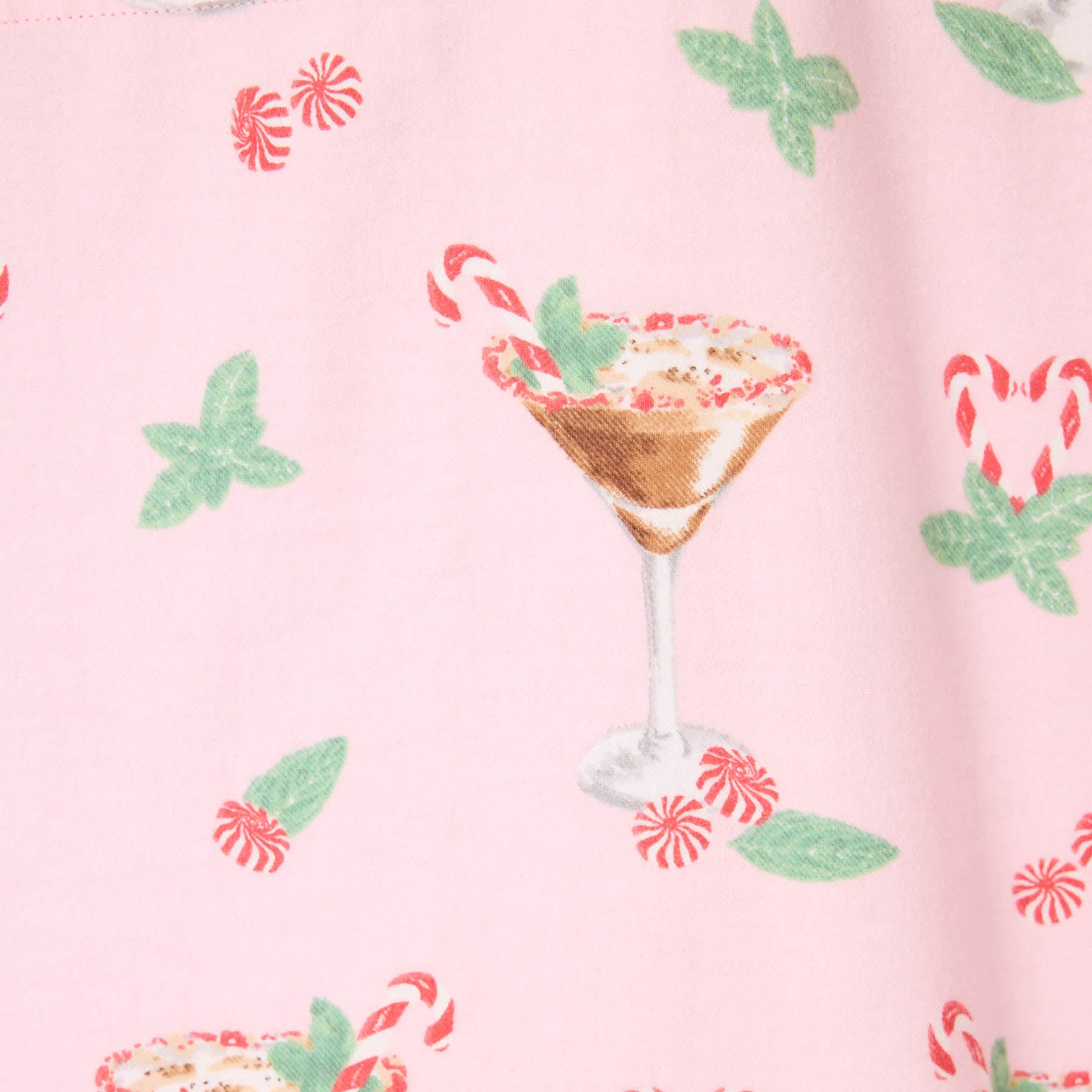 Pattern of a cocktail glass with candy cane and leaf decorations on a pink background.