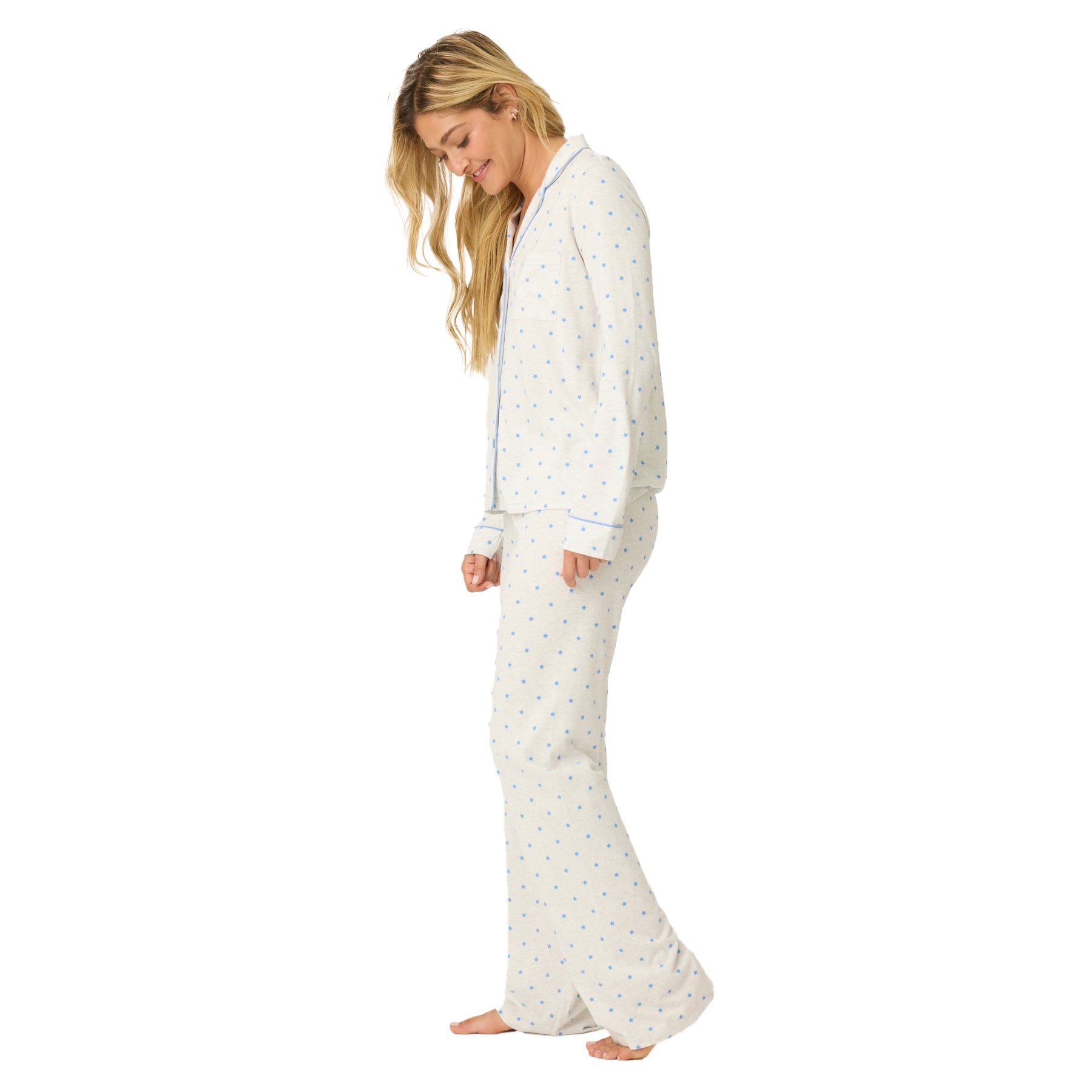 Woman wearing a white pajama set with small patterns on a white background