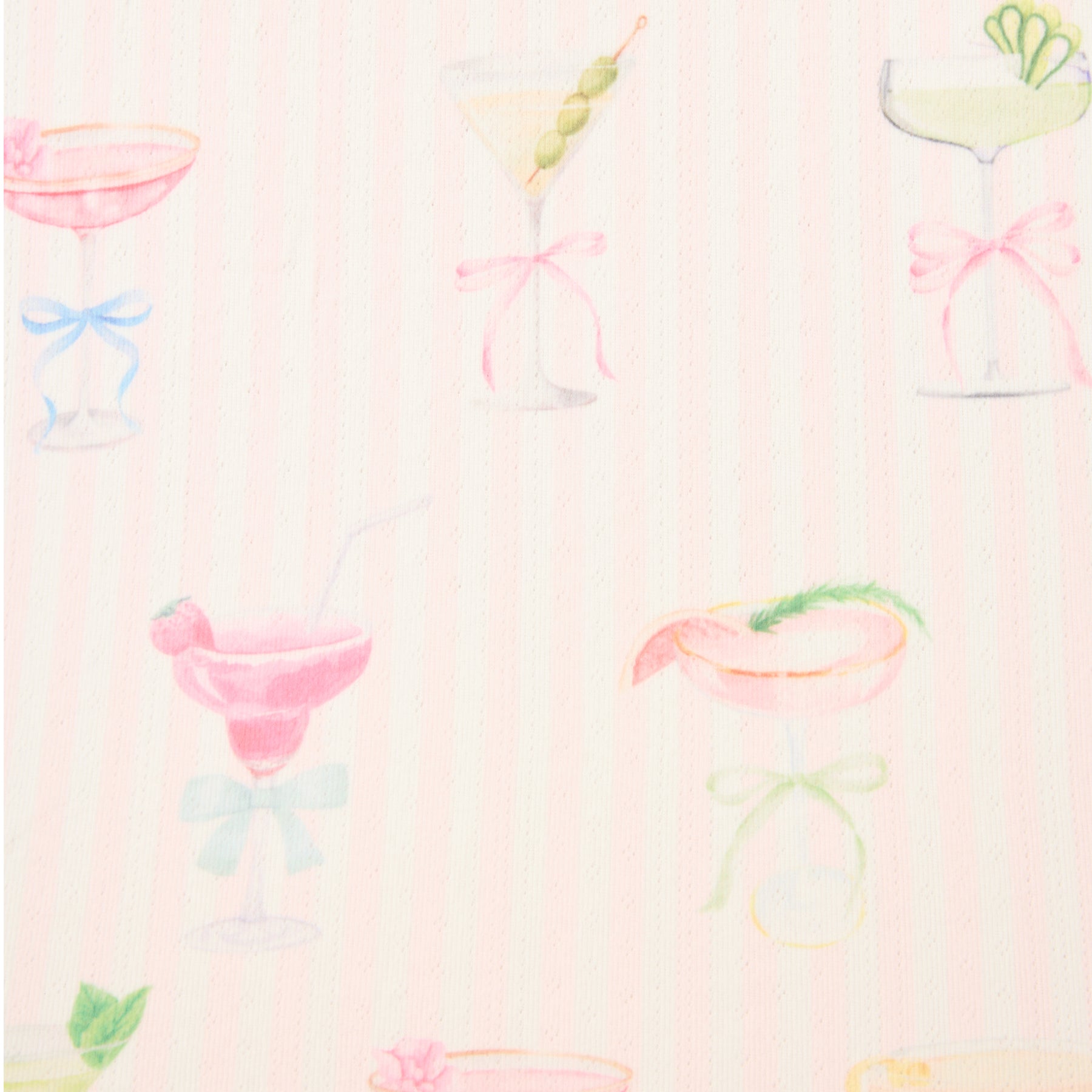 Close-up of pastel cocktail glass pattern on light pink striped pyjama fabric.
