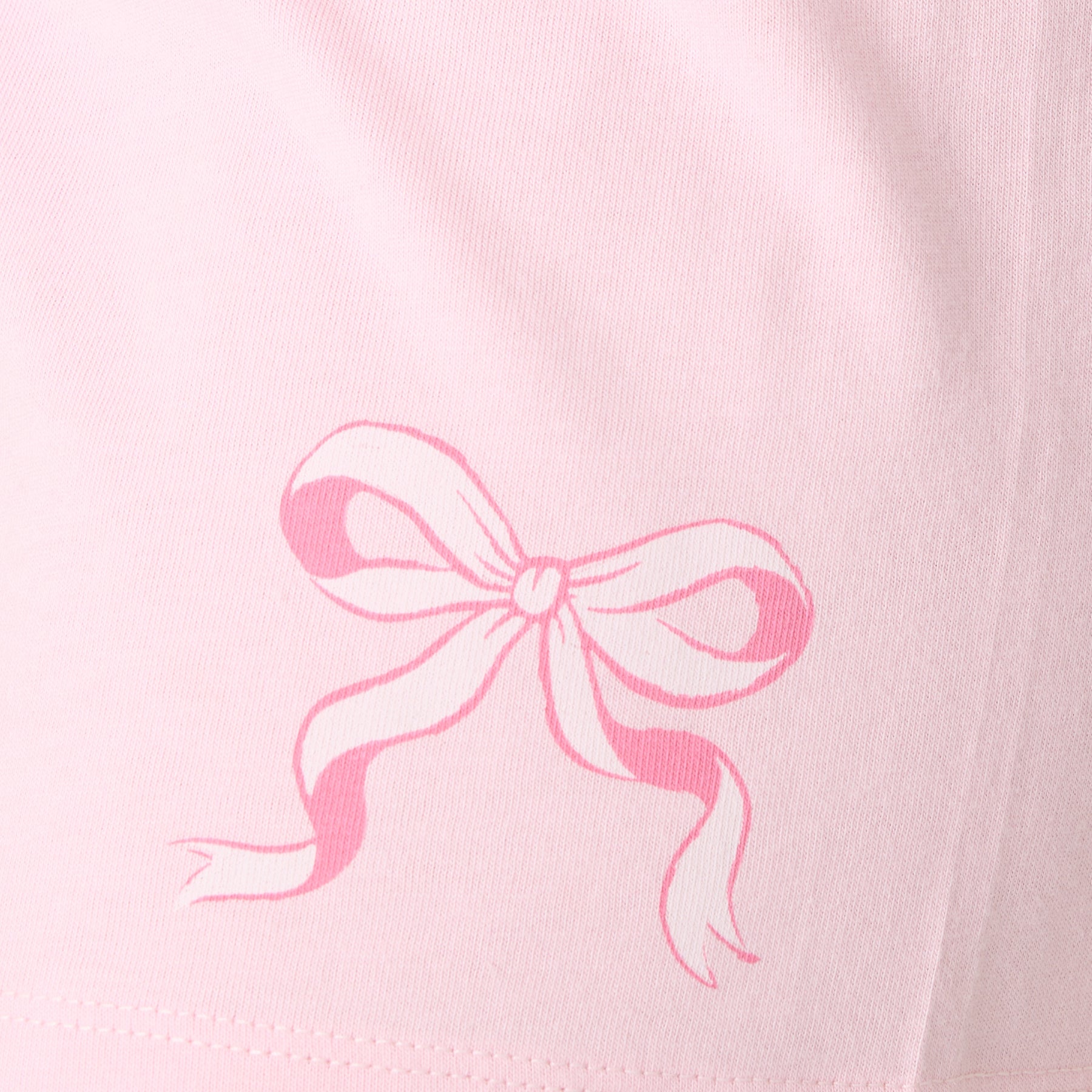 Close-up of pink bow print detail on women’s pajama shorts.